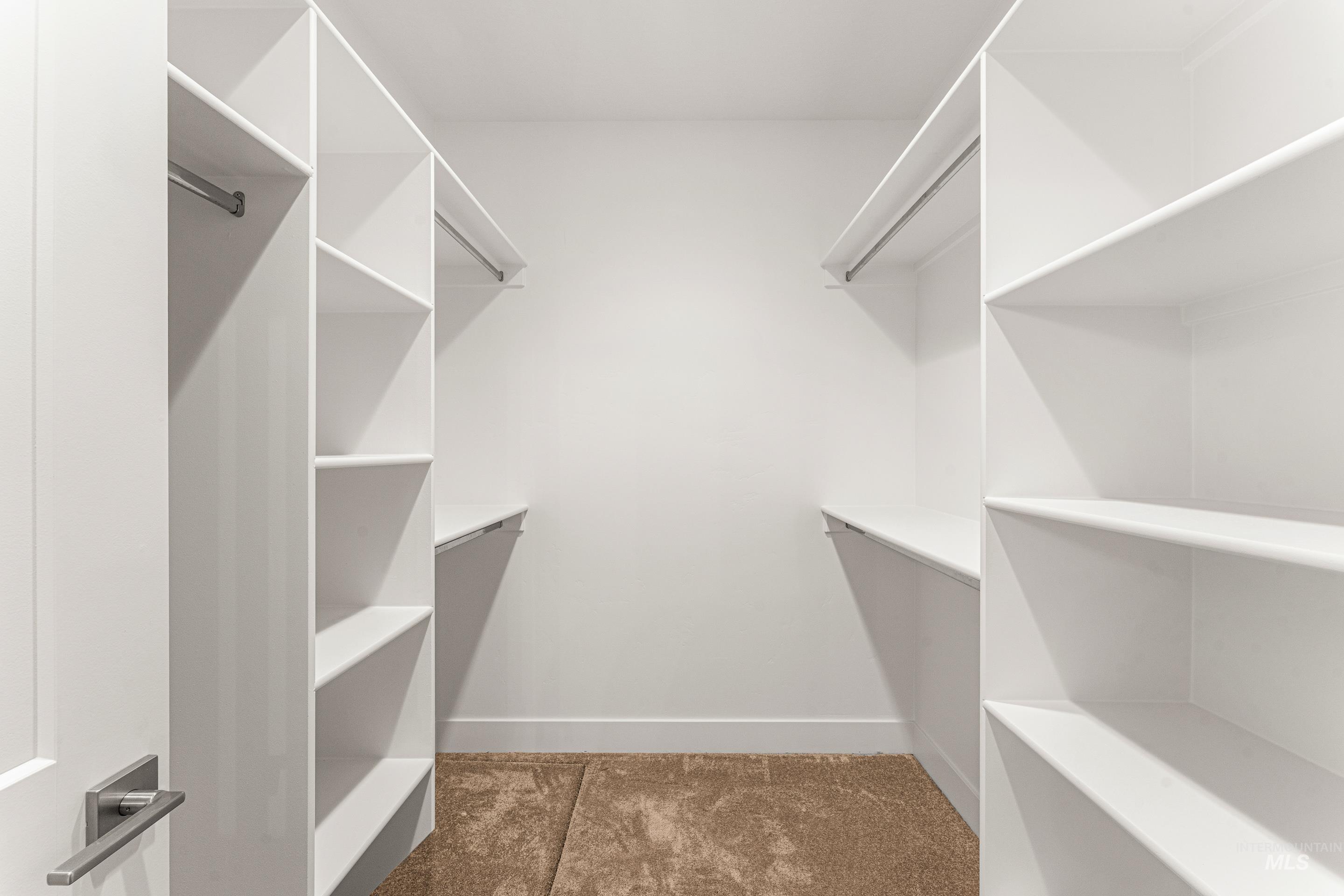 Walk in closet featuring dark tile patterned floors