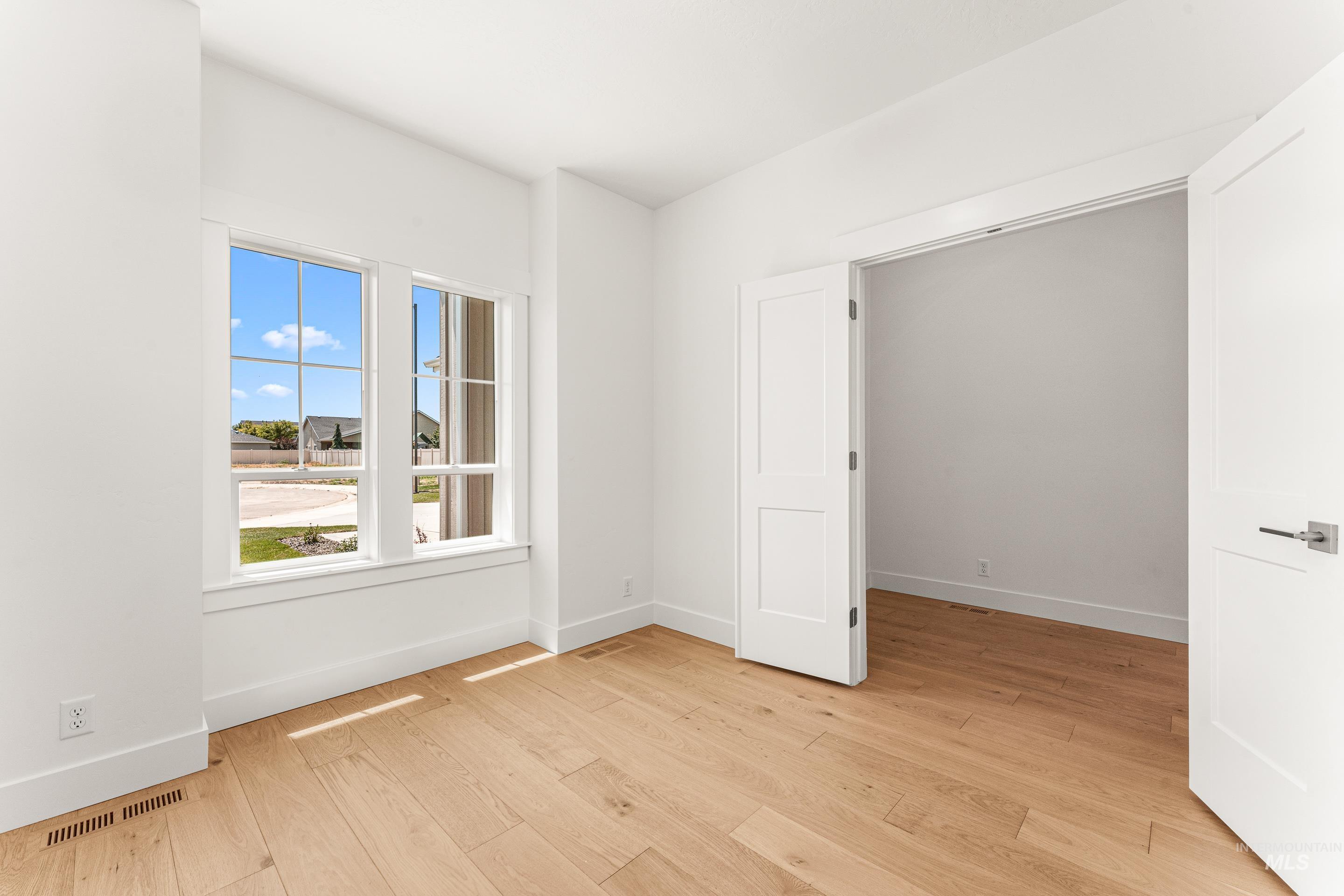 Empty room with light wood-style floors