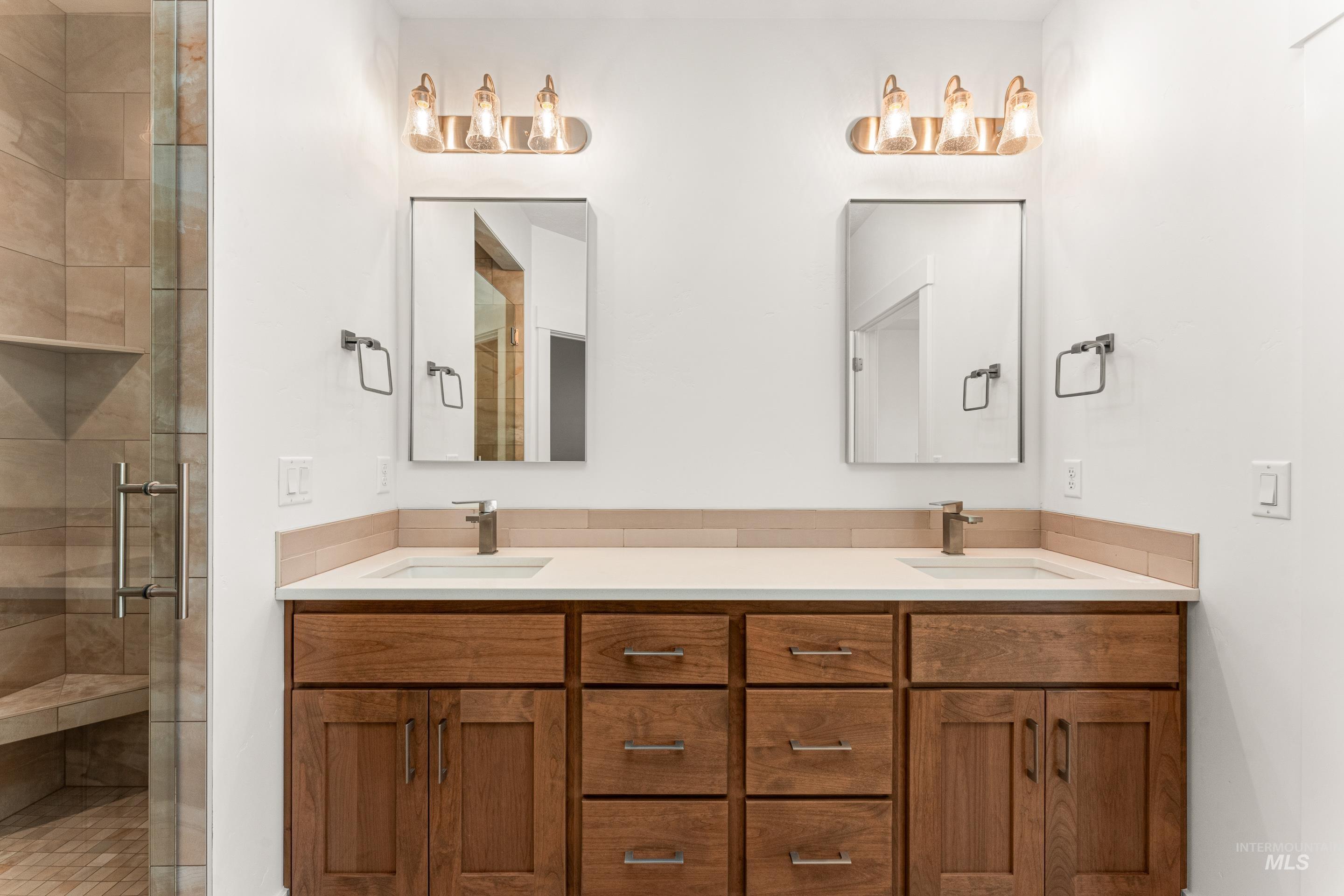 Bathroom with a stall shower and double vanity