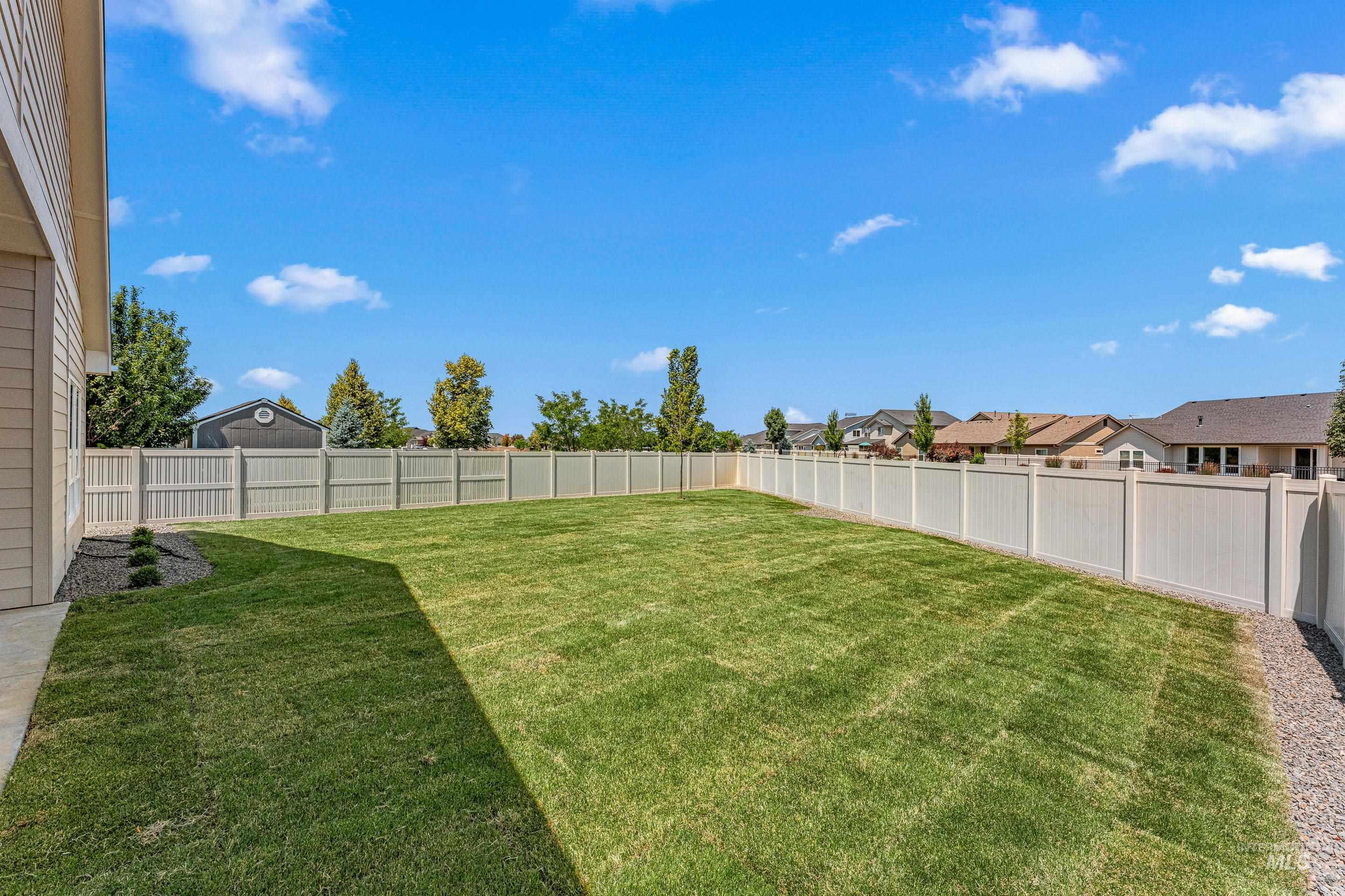 Fenced backyard with a residential view
