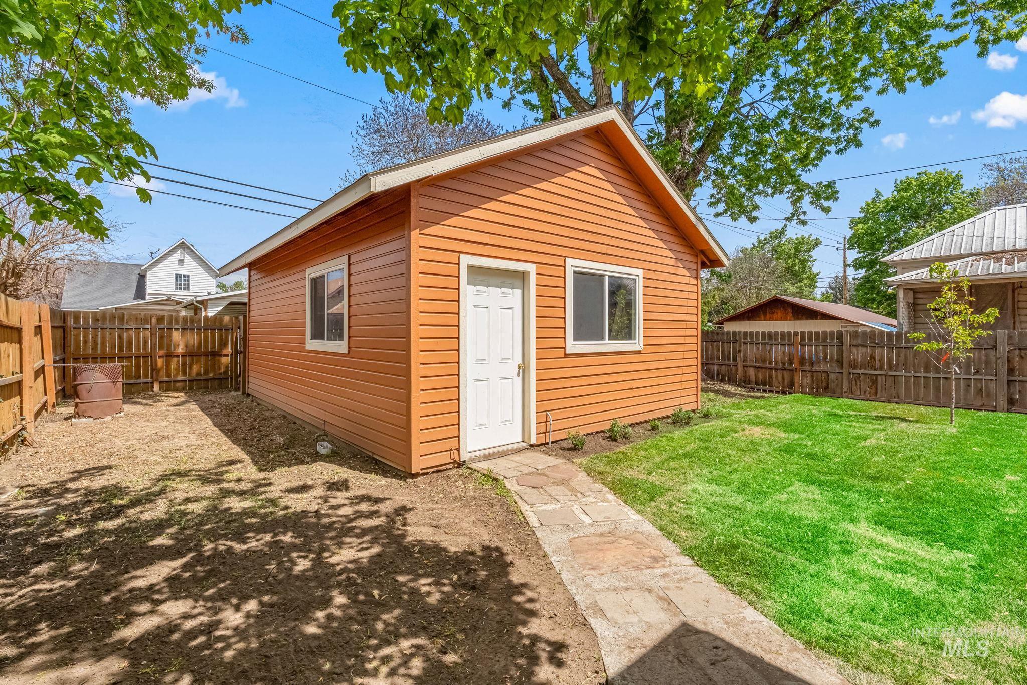 Freestanding accessory structure with horizontal siding and a gable roof
