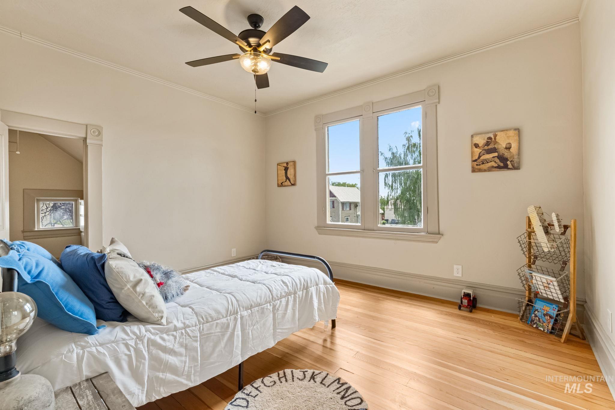 Hardwood flooring complemented by a window with detailed trim