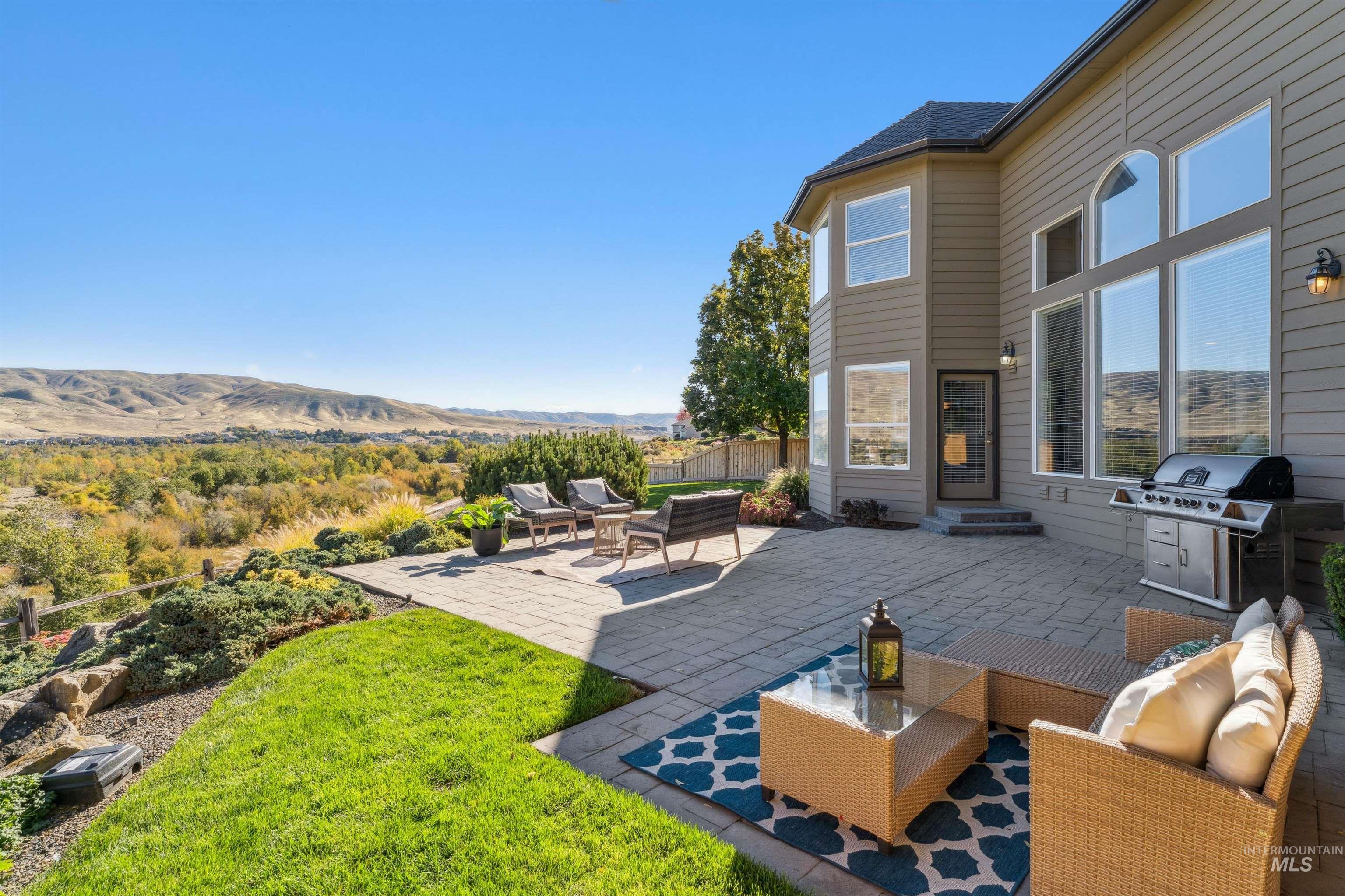 View of patio / terrace with outdoor lounge area, a grill, and a mountain view