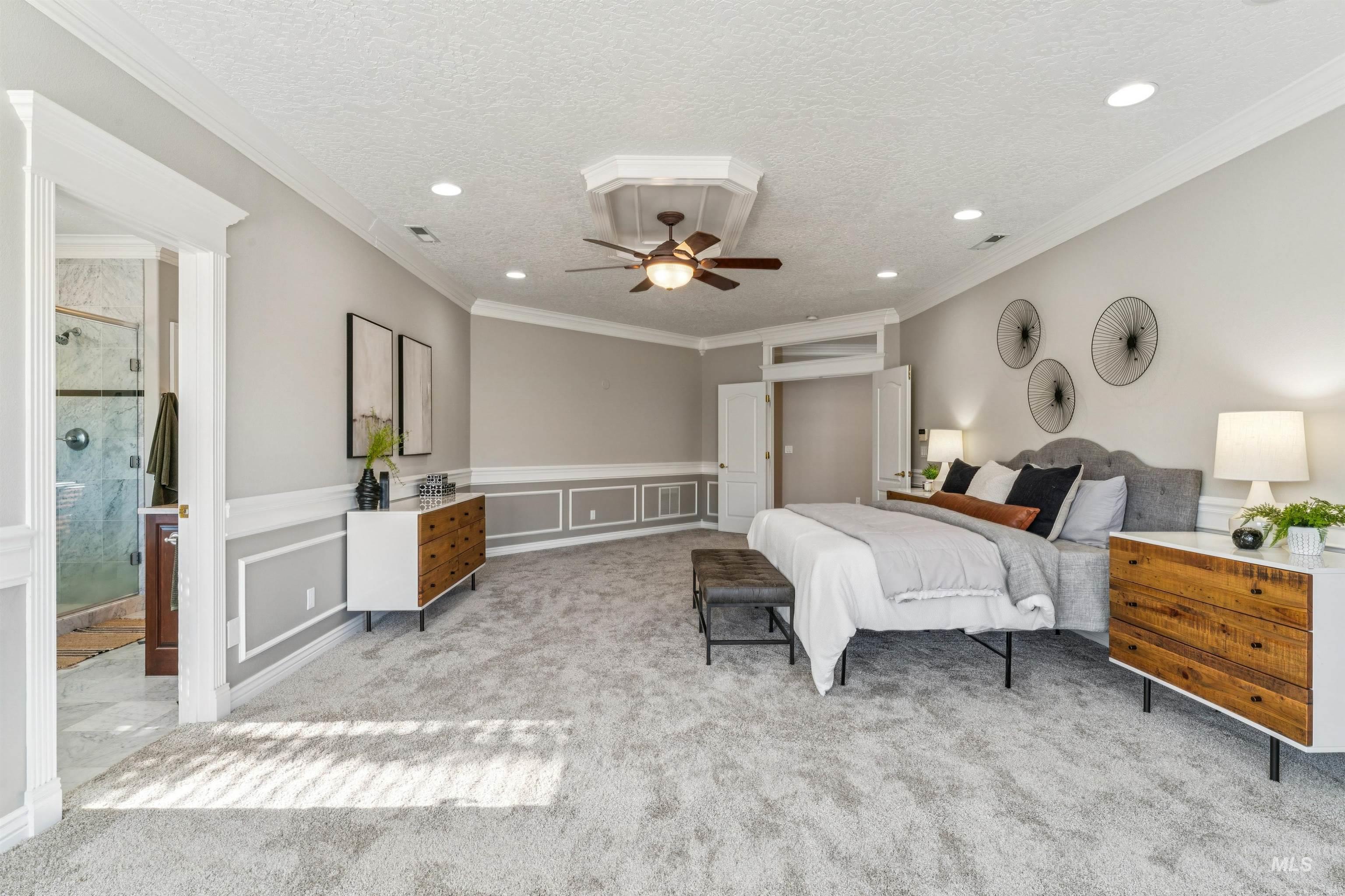 Bedroom featuring ornamental molding, a textured ceiling, a ceiling fan, and light colored carpet