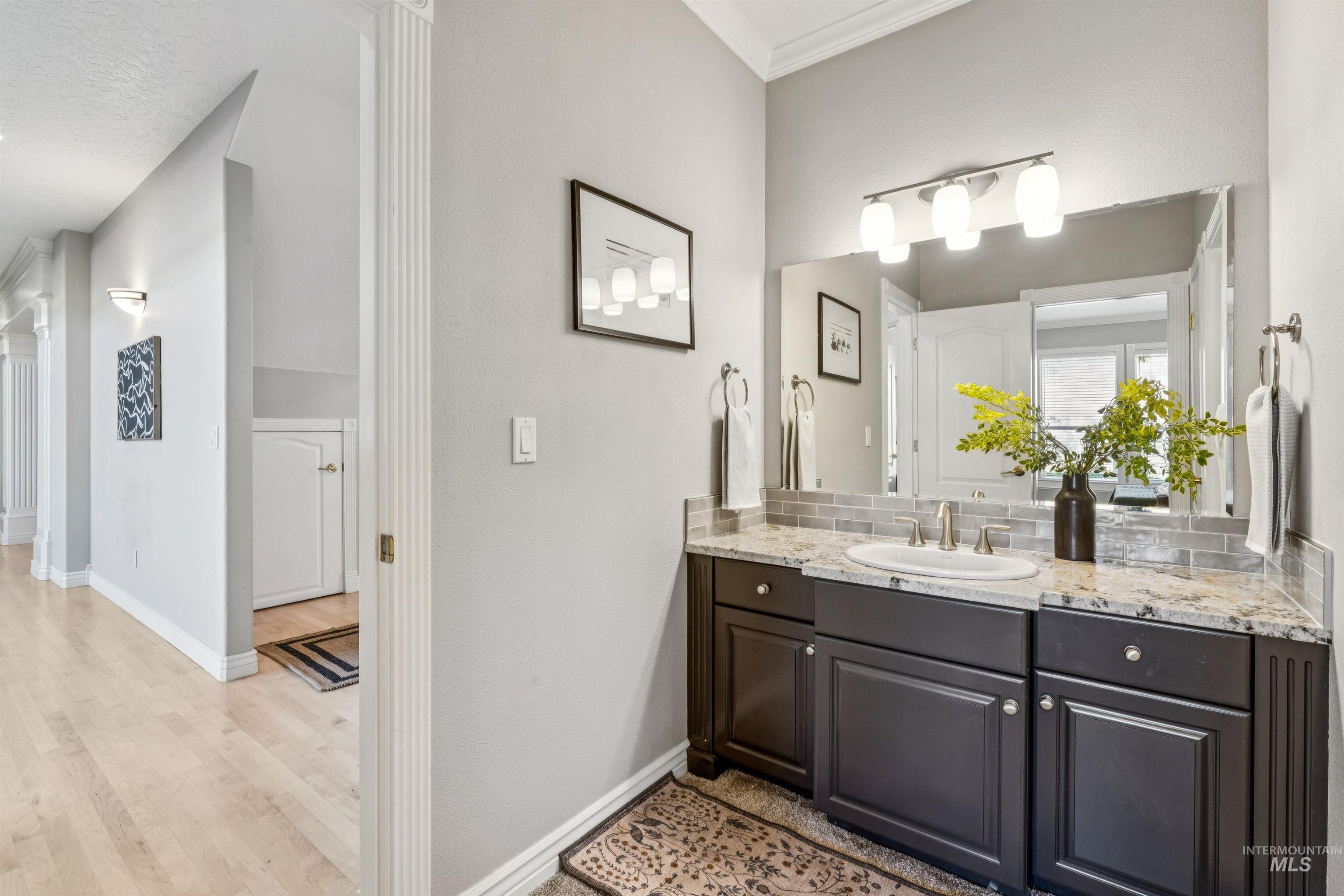 Bathroom featuring vanity and light wood finished floors