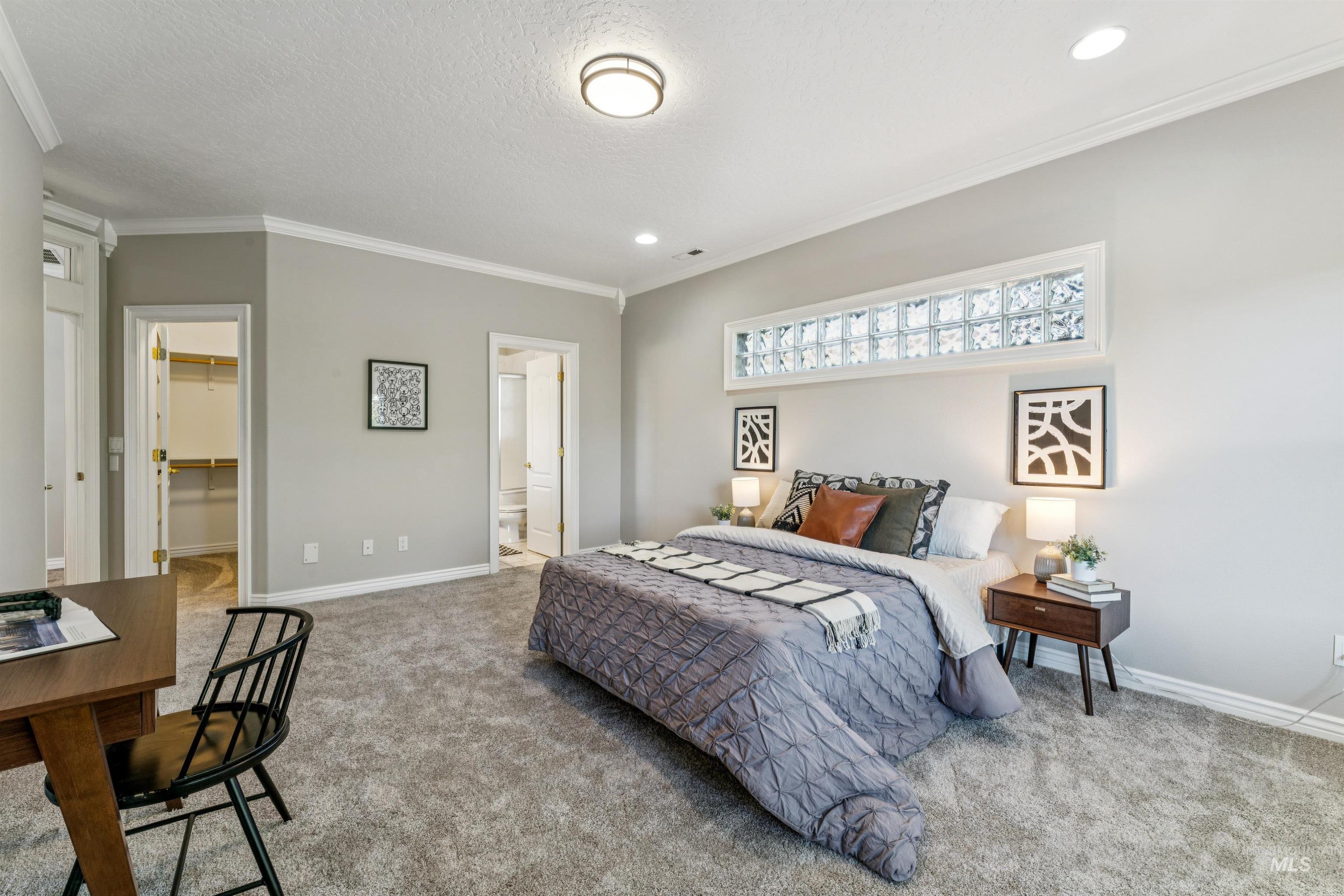 Bedroom featuring ornamental molding, carpet, a spacious closet, a textured ceiling, and recessed lighting