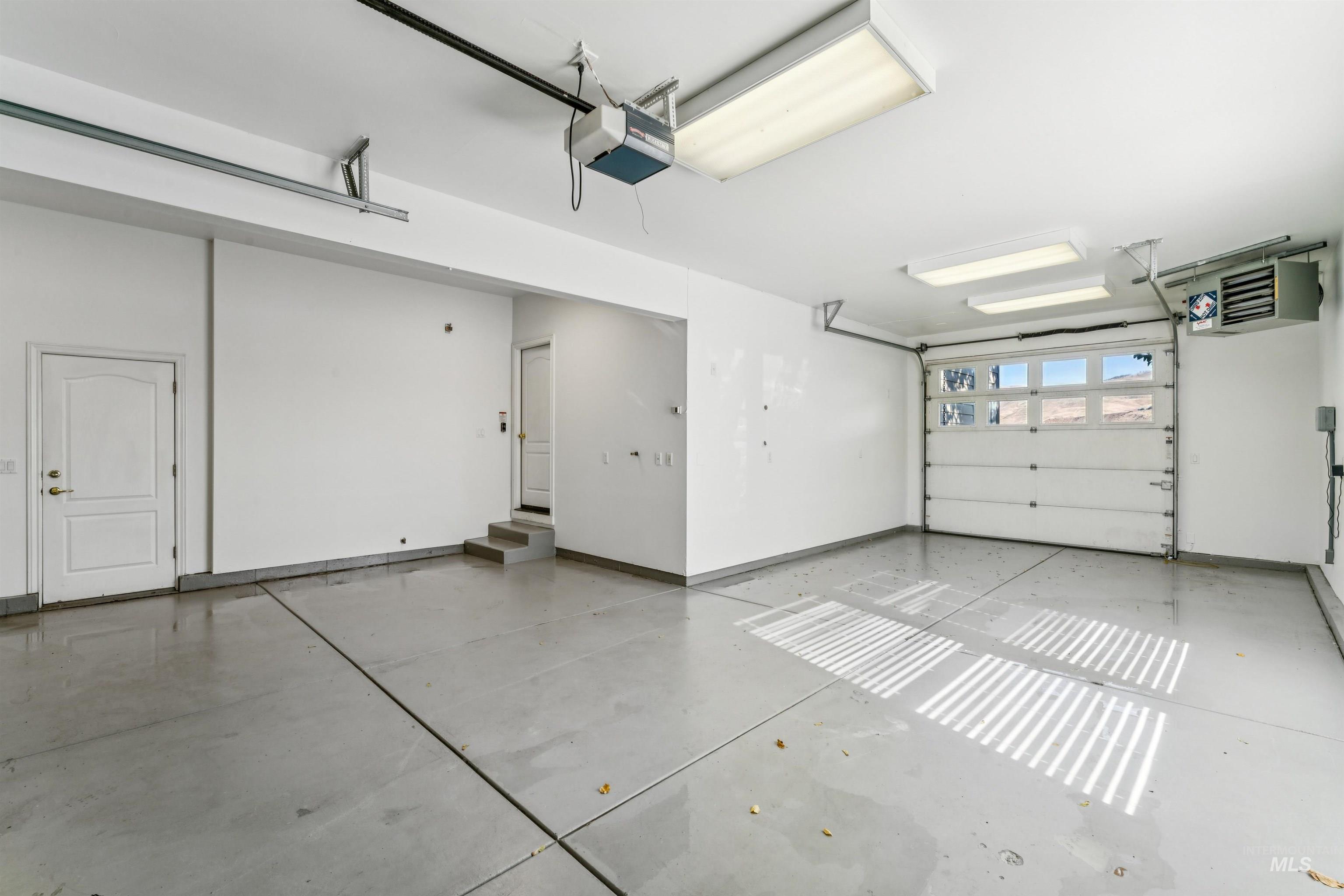 Garage with a heating unit and a garage door opener