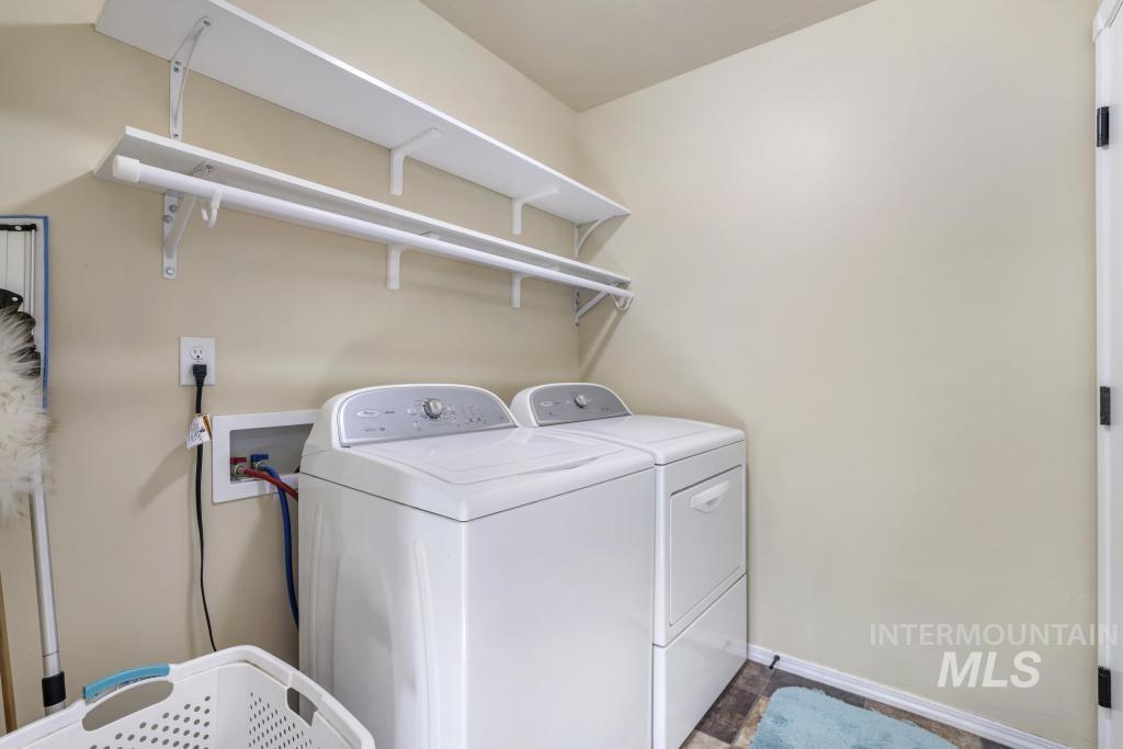 Laundry area featuring washing machine and dryer and baseboards