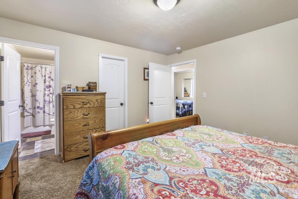 Bedroom with carpet floors and ensuite bathroom