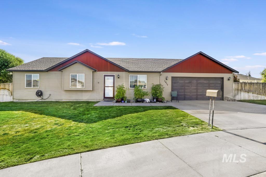 Ranch-style house featuring driveway, an attached garage, and roof with shingles