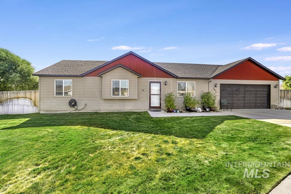 Ranch-style house with driveway, a garage, and a shingled roof