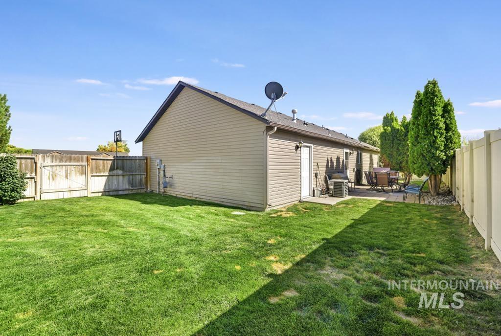 Back of property featuring a fenced backyard, a gate, and a patio