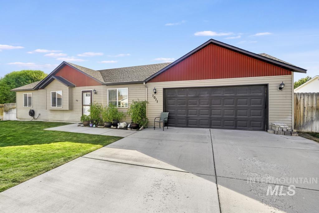Single story home with concrete driveway, roof with shingles, and a garage