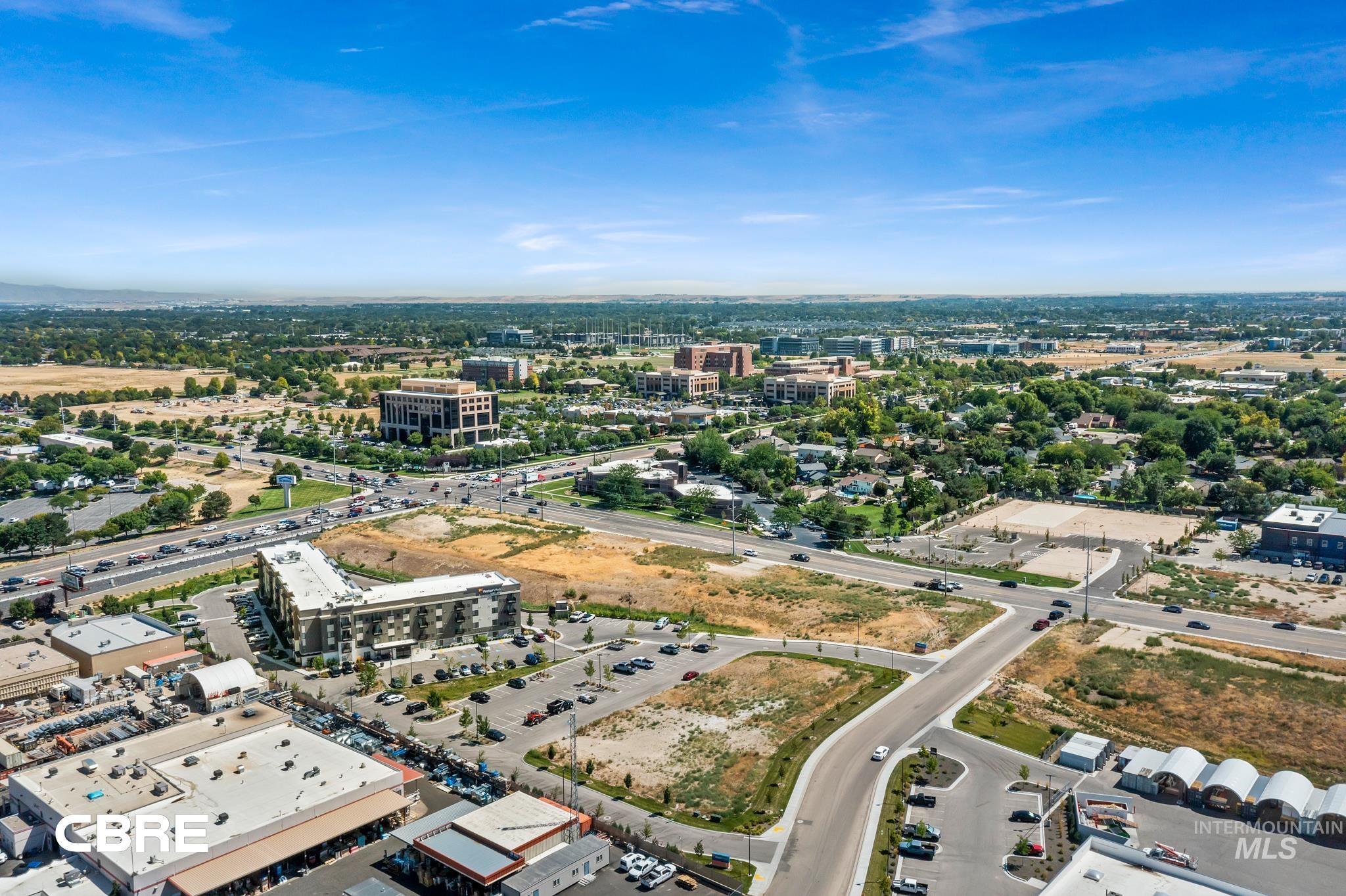 Aerial view of property and surrounding area with nearby urban area