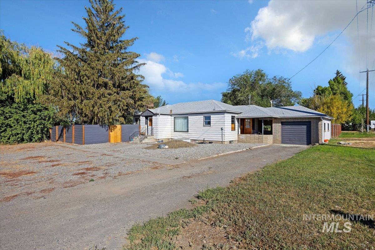 Ranch-style home with a garage, driveway, and crawl space