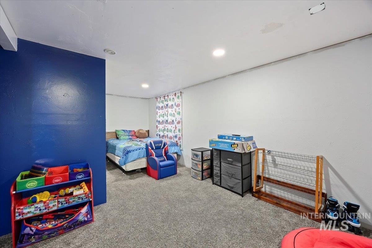 Carpeted bedroom with recessed lighting