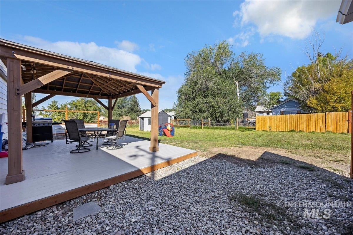 View of yard with a storage shed, a wooden deck, and a gazebo