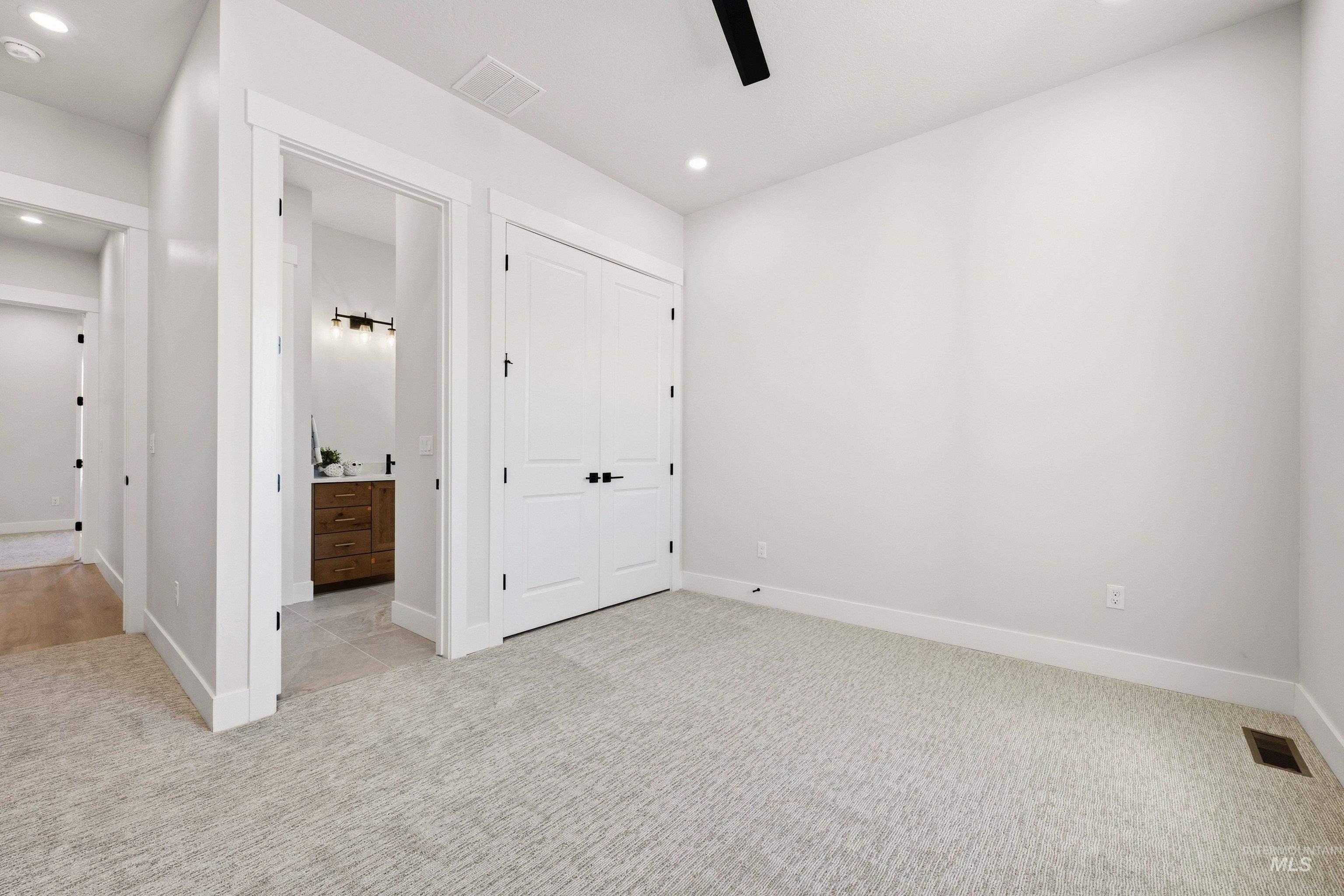 Unfurnished bedroom with light colored carpet, a closet, ceiling fan, and recessed lighting