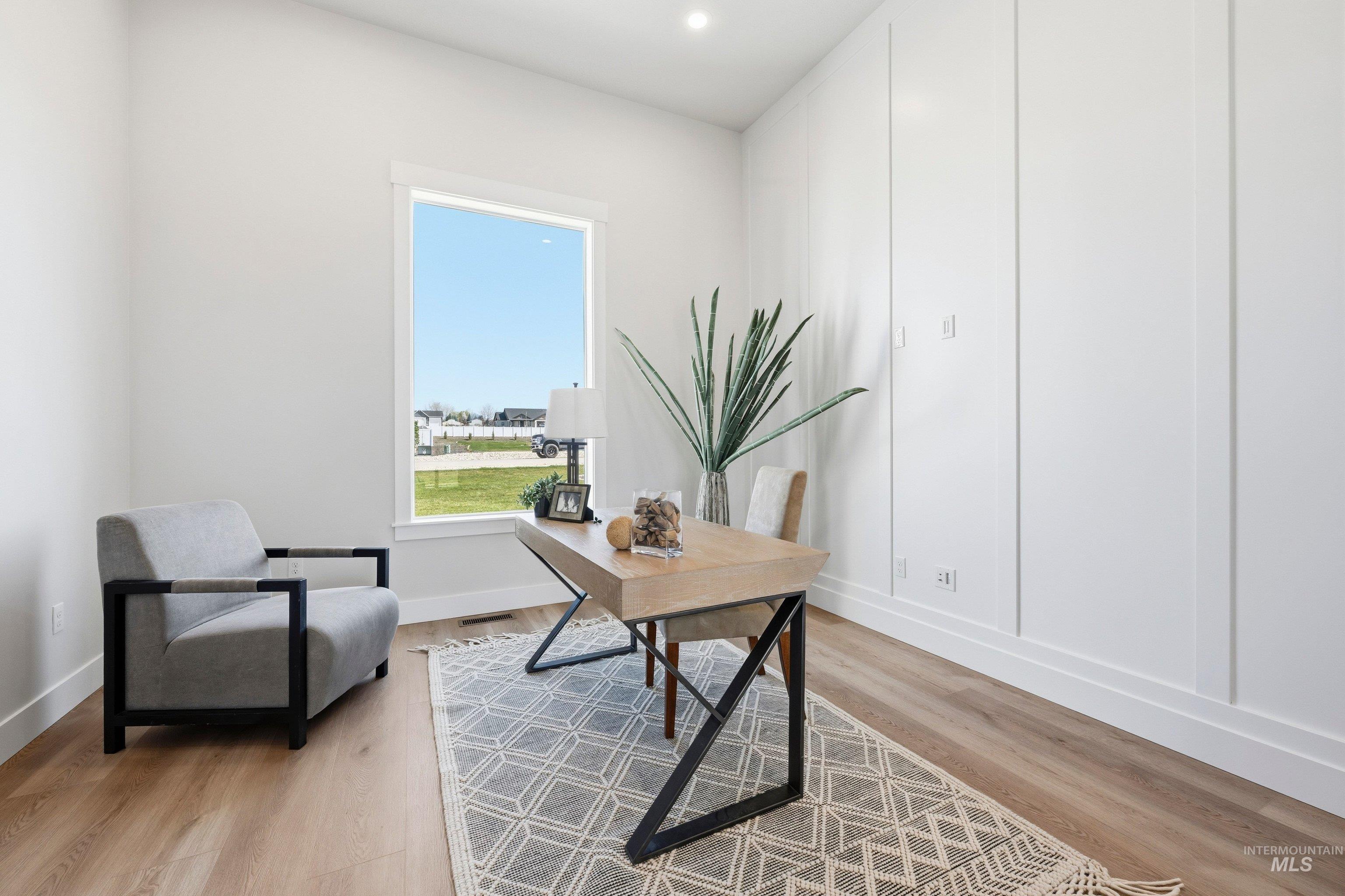 Office area featuring light wood-type flooring and recessed lighting