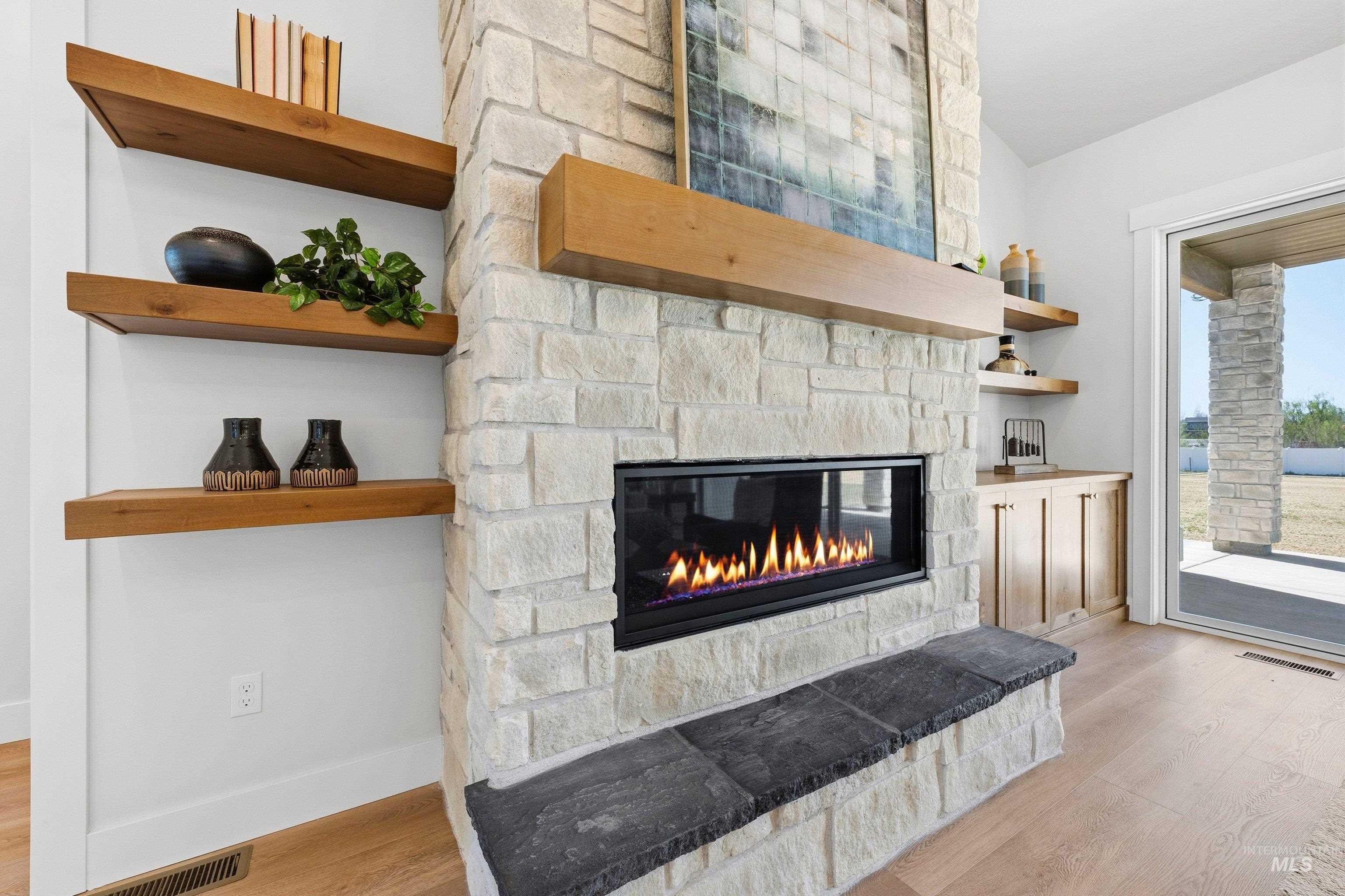 Detailed view of wood finished floors and a fireplace