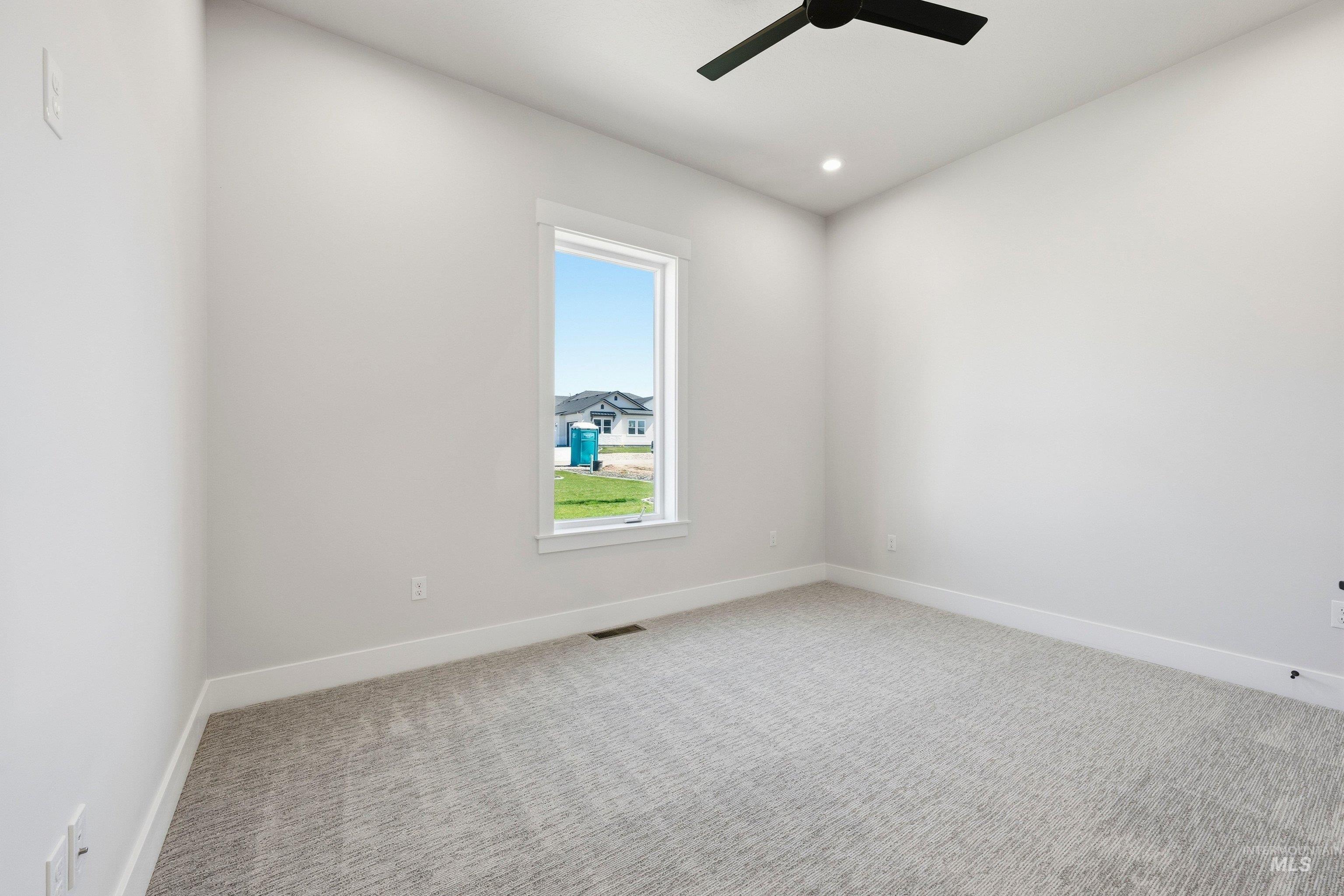 Empty room featuring light carpet, recessed lighting, and a ceiling fan