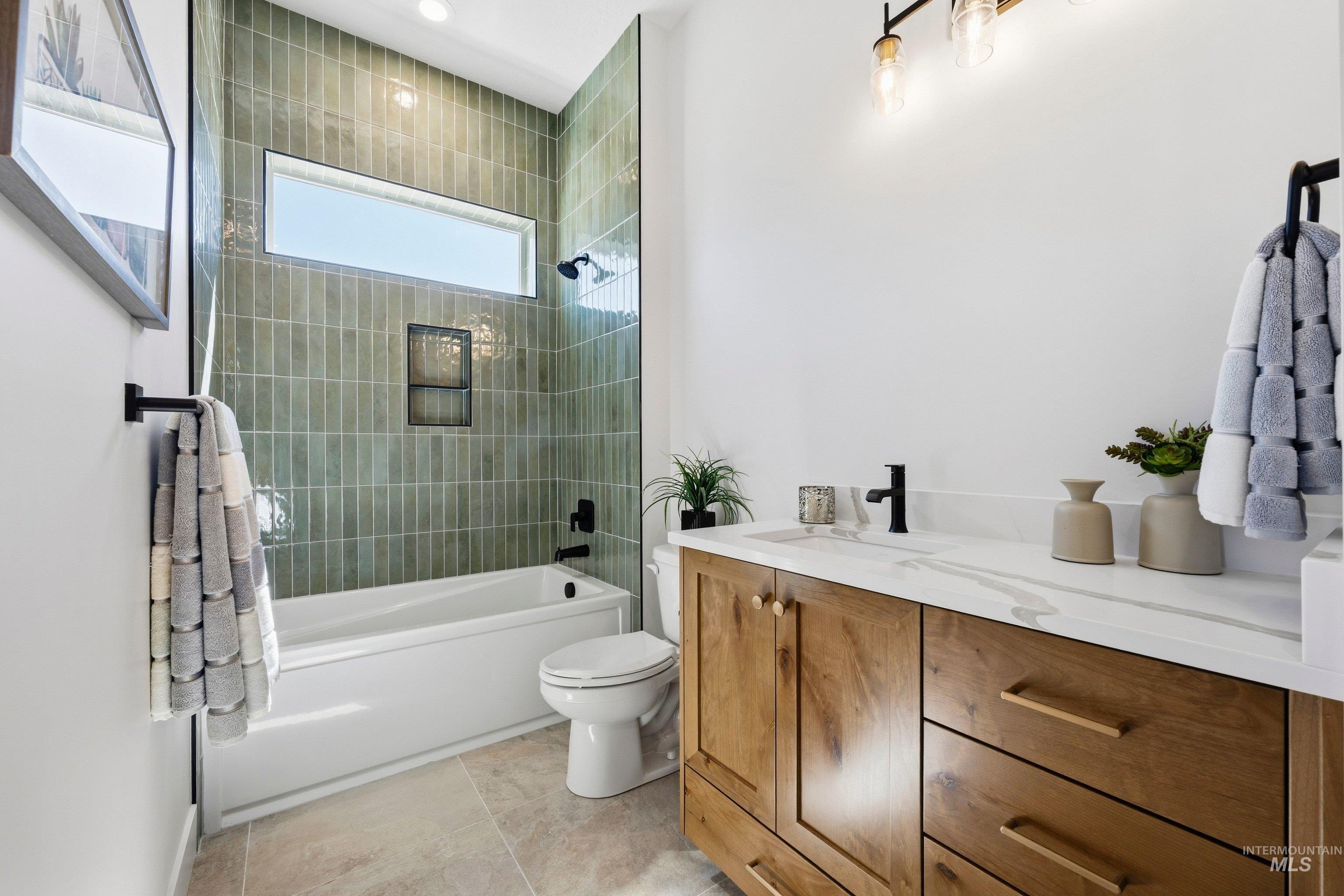 Full bath with vanity, tub / shower combination, and light tile patterned floors