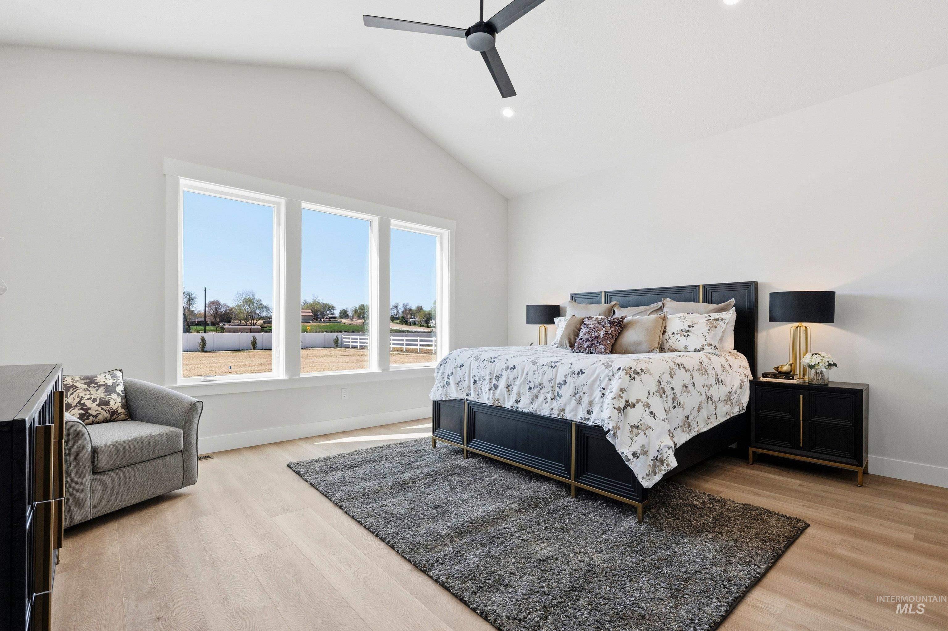 Bedroom with lofted ceiling, light wood-style flooring, ceiling fan, and recessed lighting