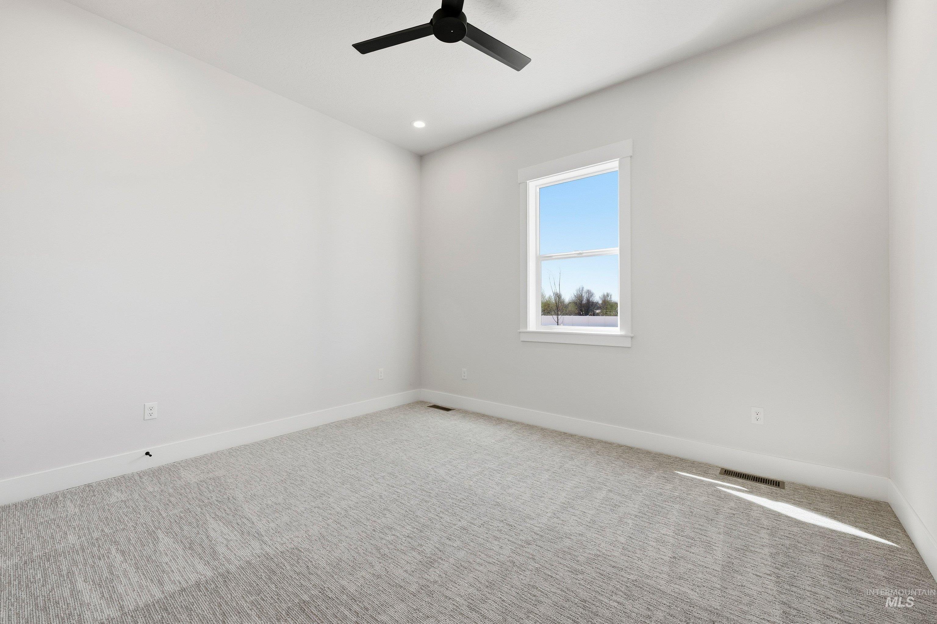 Spare room with carpet, ceiling fan, and recessed lighting