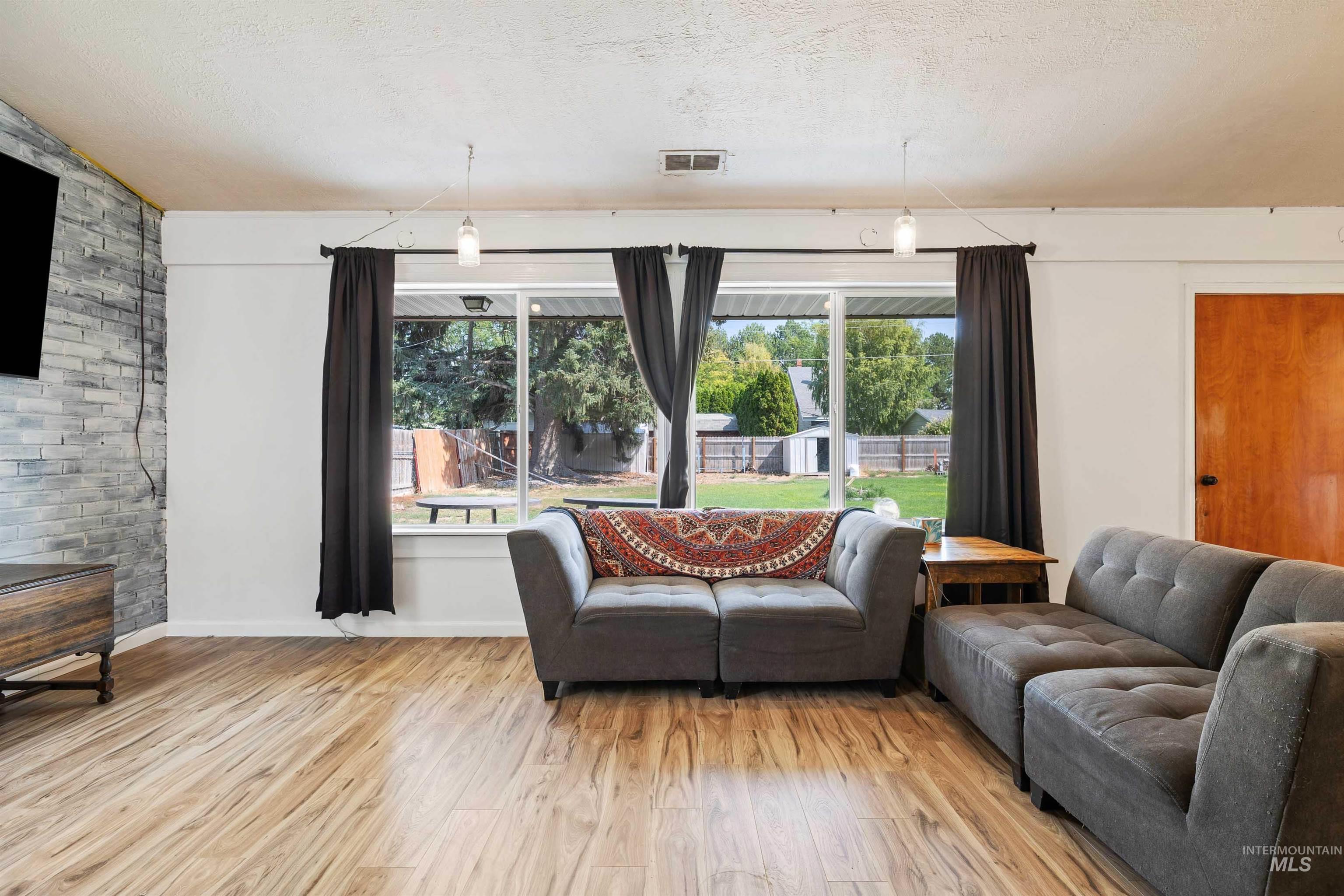 Living room featuring wood finished floors and a textured ceiling