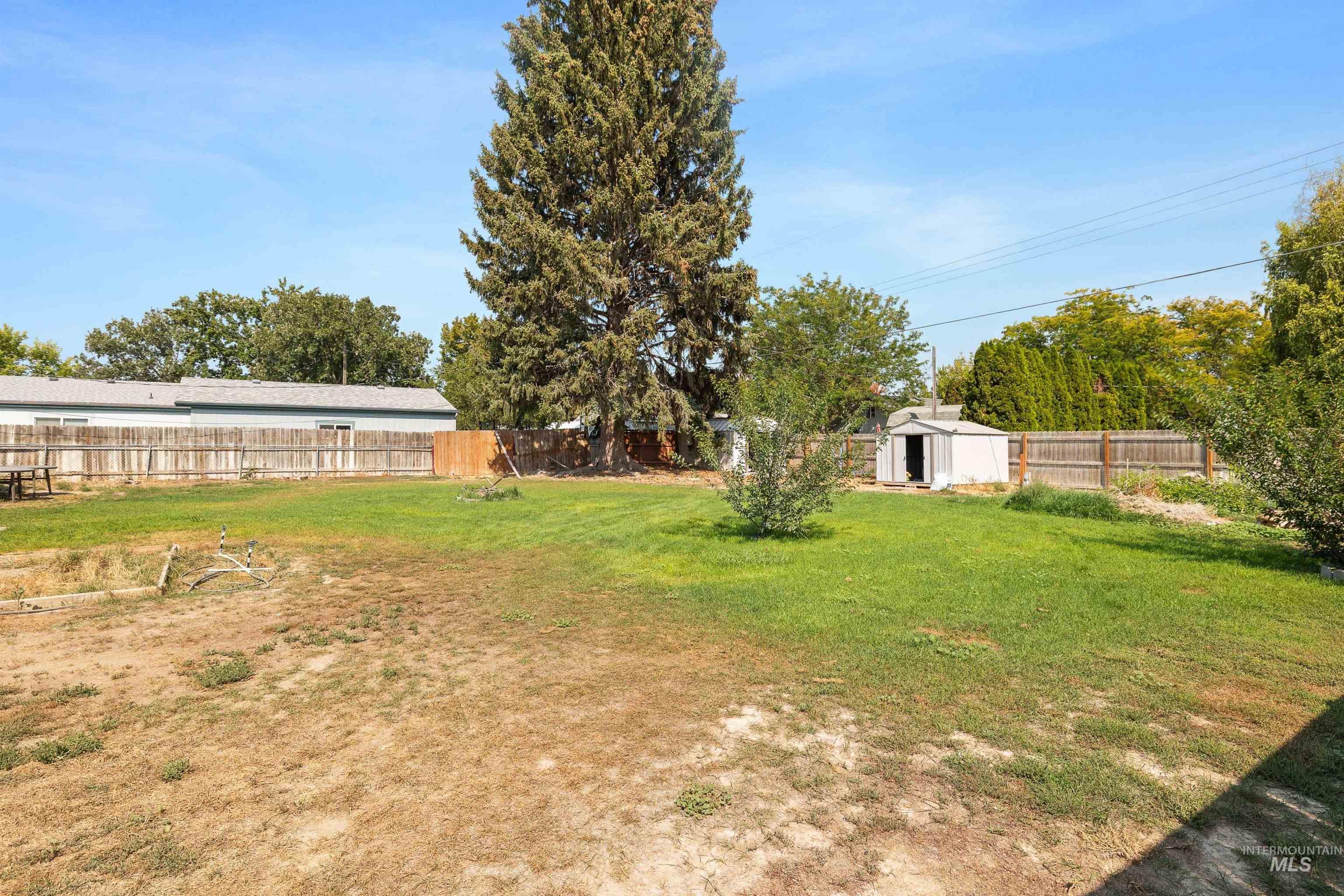 Fenced backyard with a storage unit