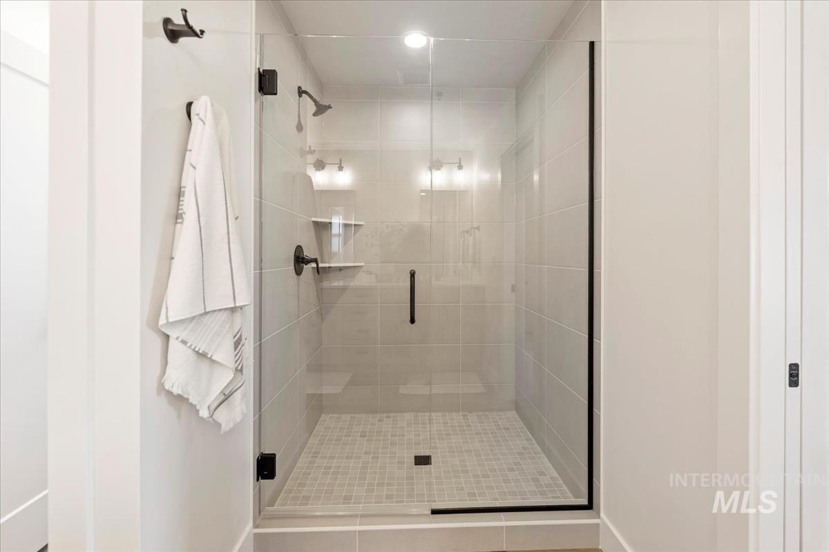 Full bathroom with a stall shower, tile patterned flooring, and recessed lighting