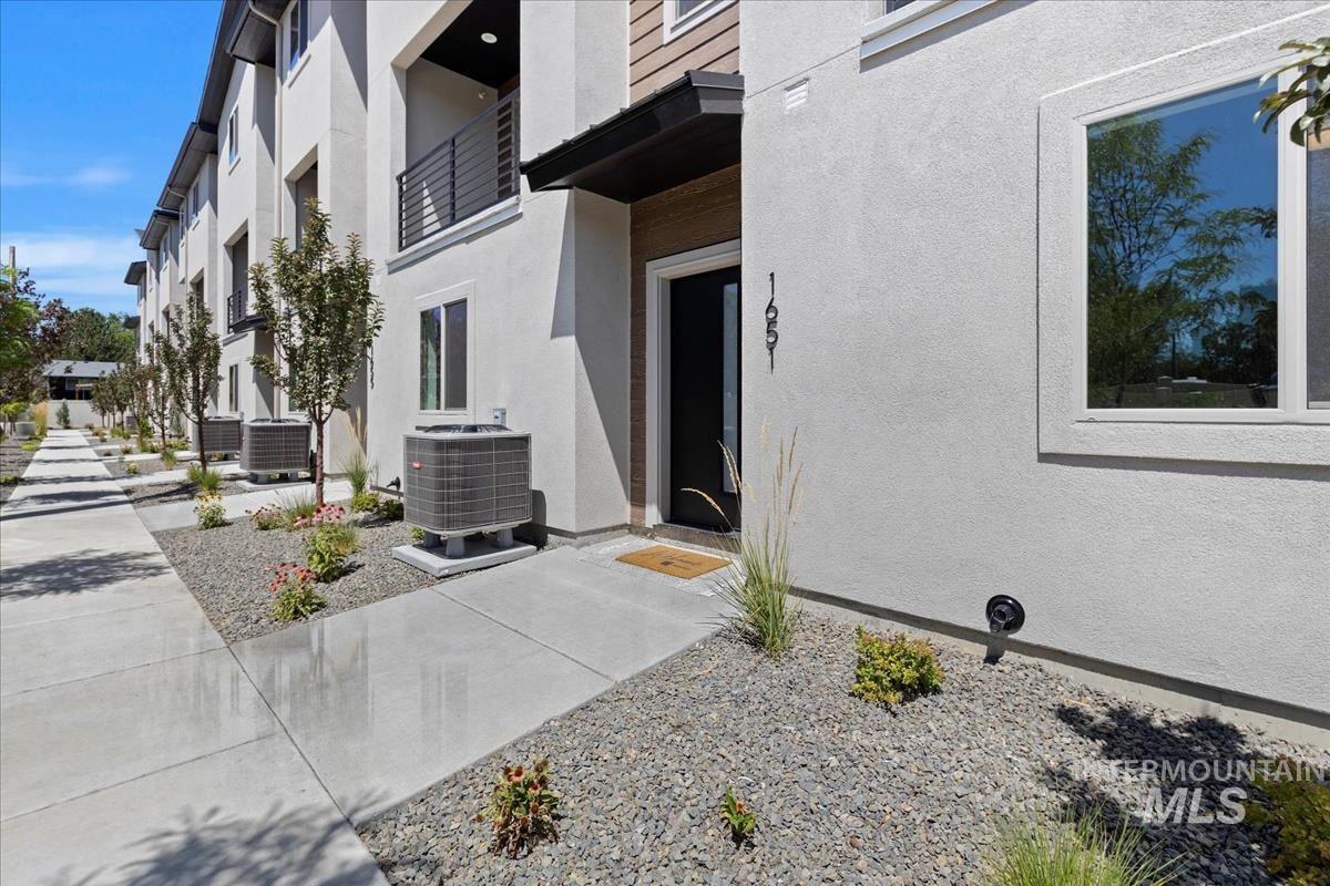 View of exterior entry featuring stucco siding