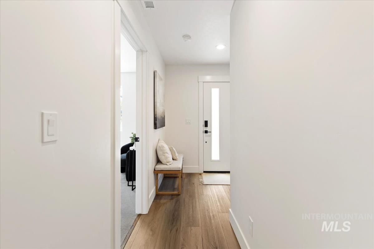 Hall featuring baseboards and wood finished floors