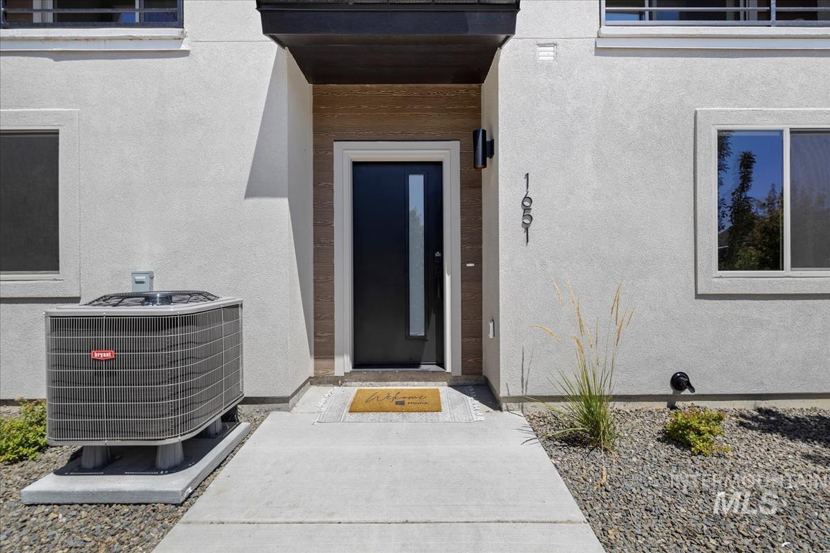 View of exterior entry featuring stucco siding