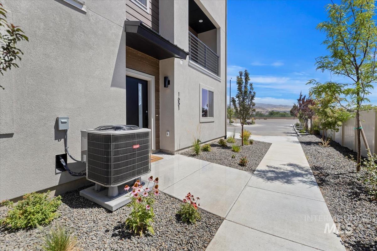 View of property exterior with a cooling unit and stucco siding