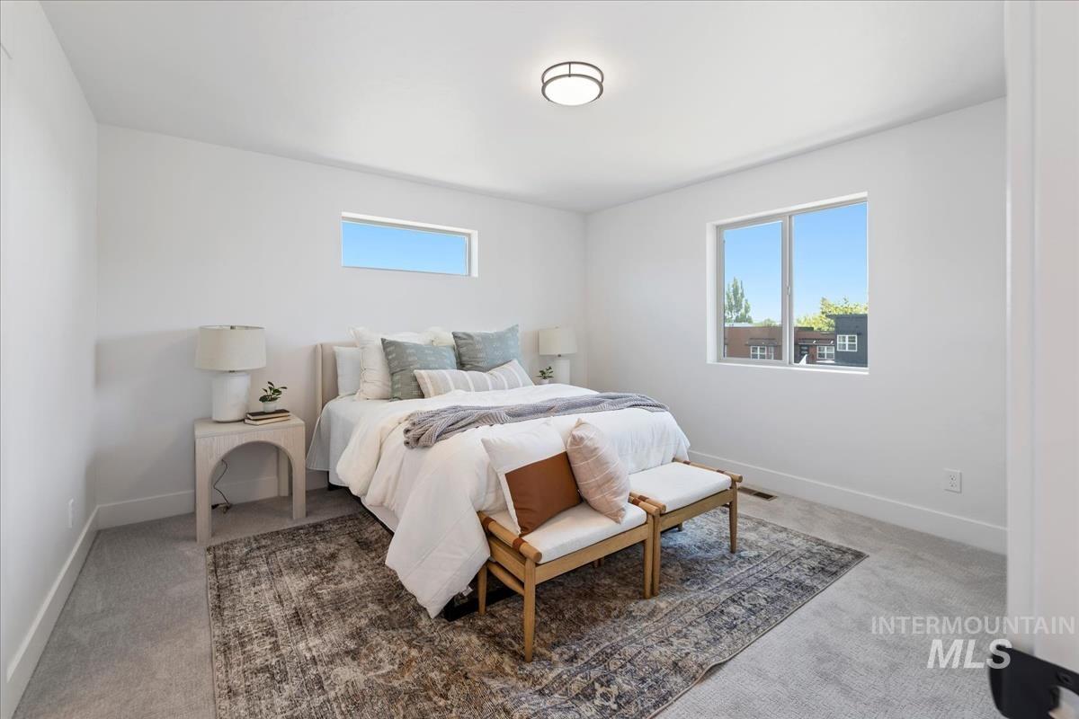 Bedroom with light colored carpet