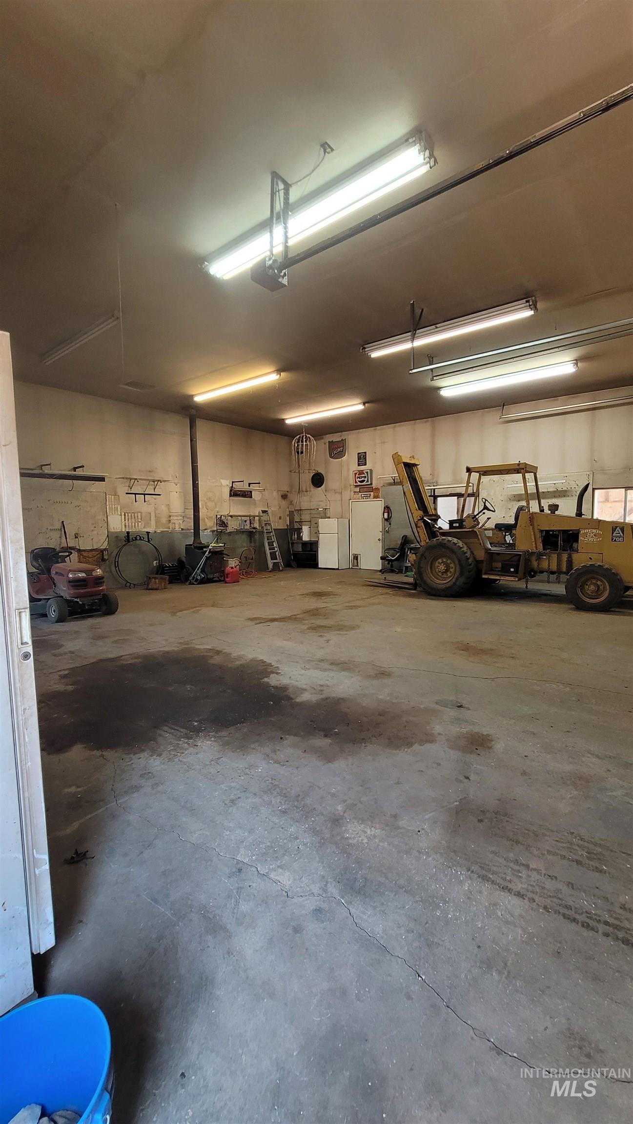 Garage featuring freestanding refrigerator