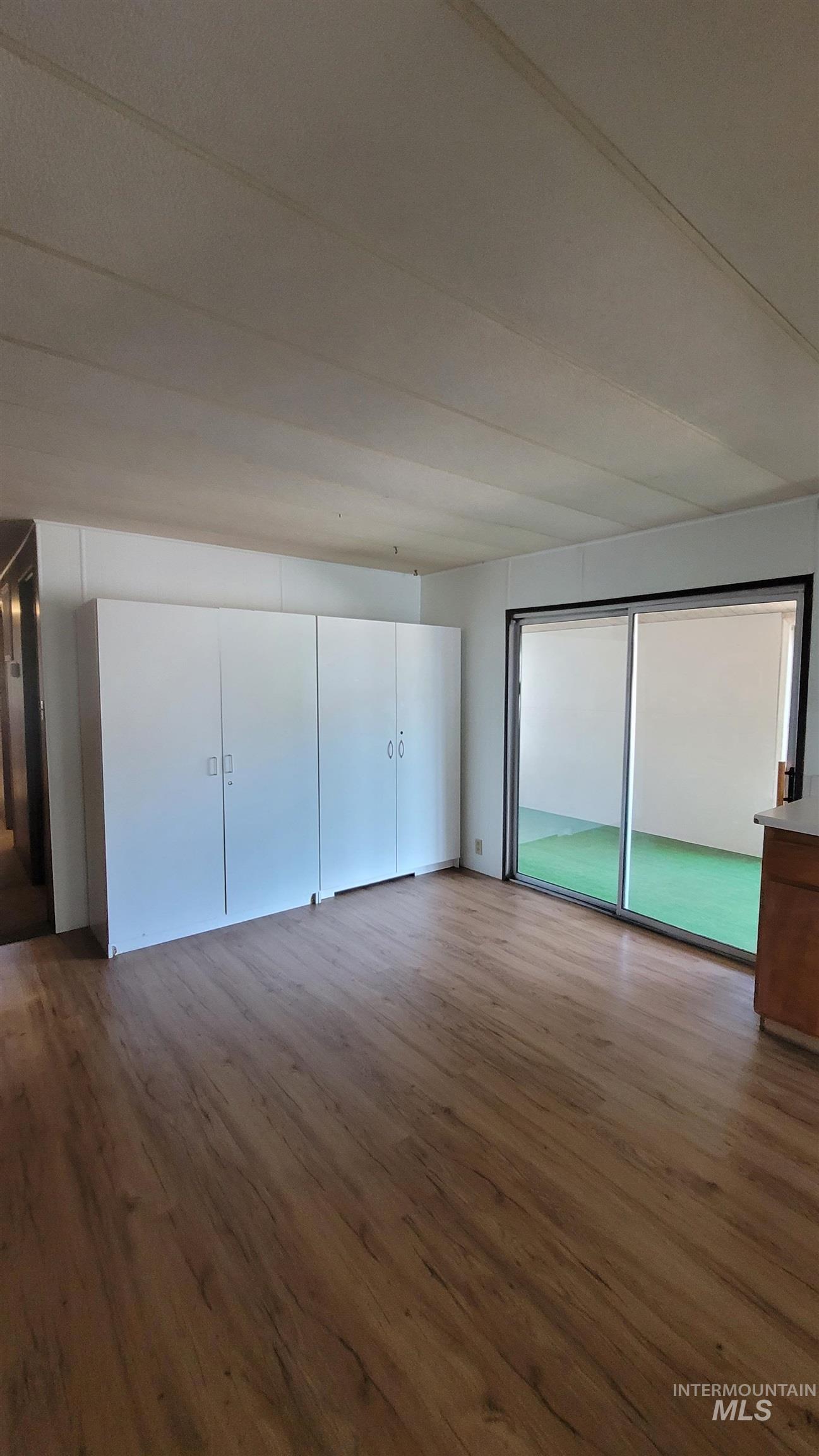 Unfurnished bedroom with a closet and dark wood-style flooring