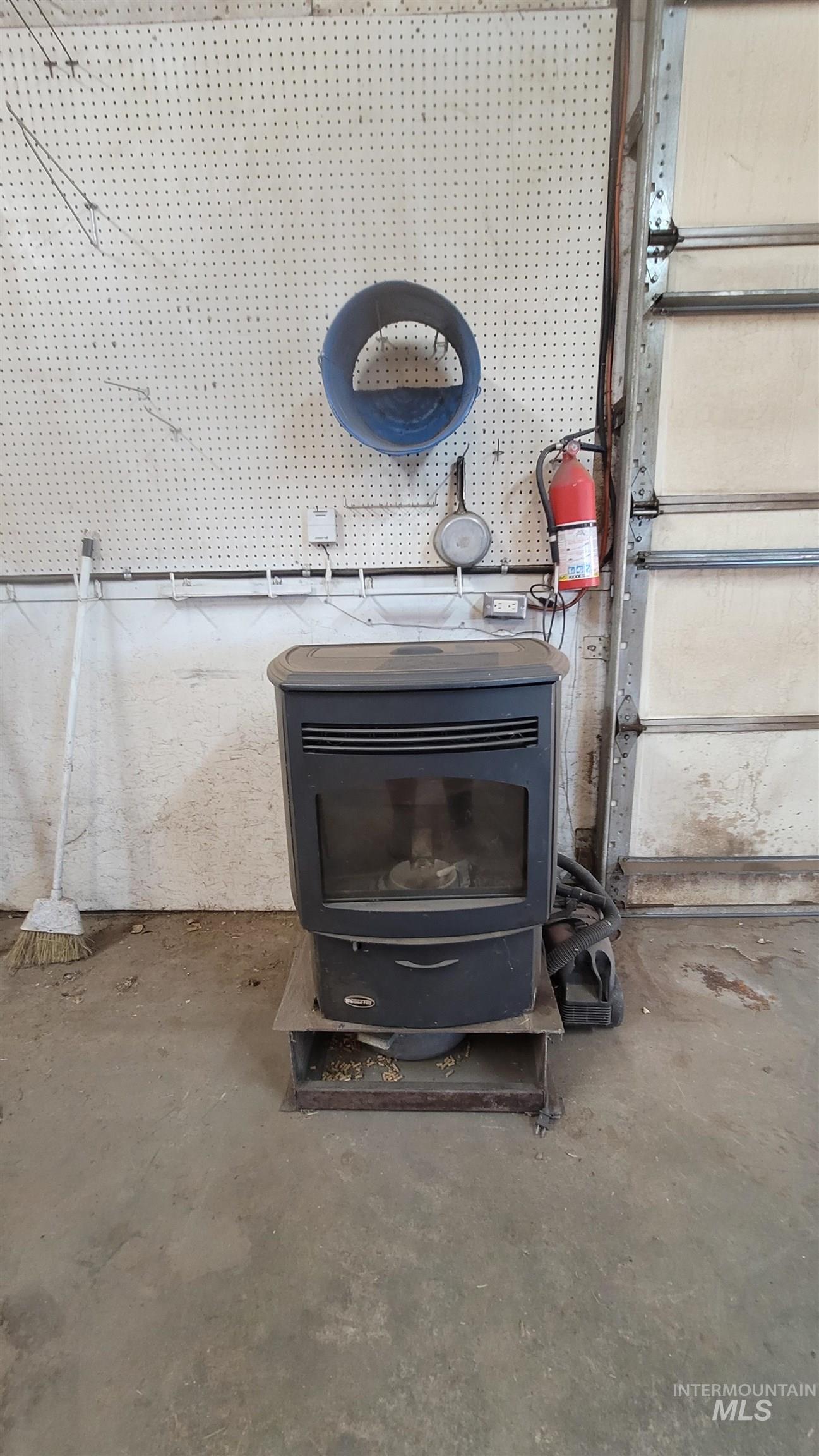Detailed view of unfinished concrete floors and a wood stove