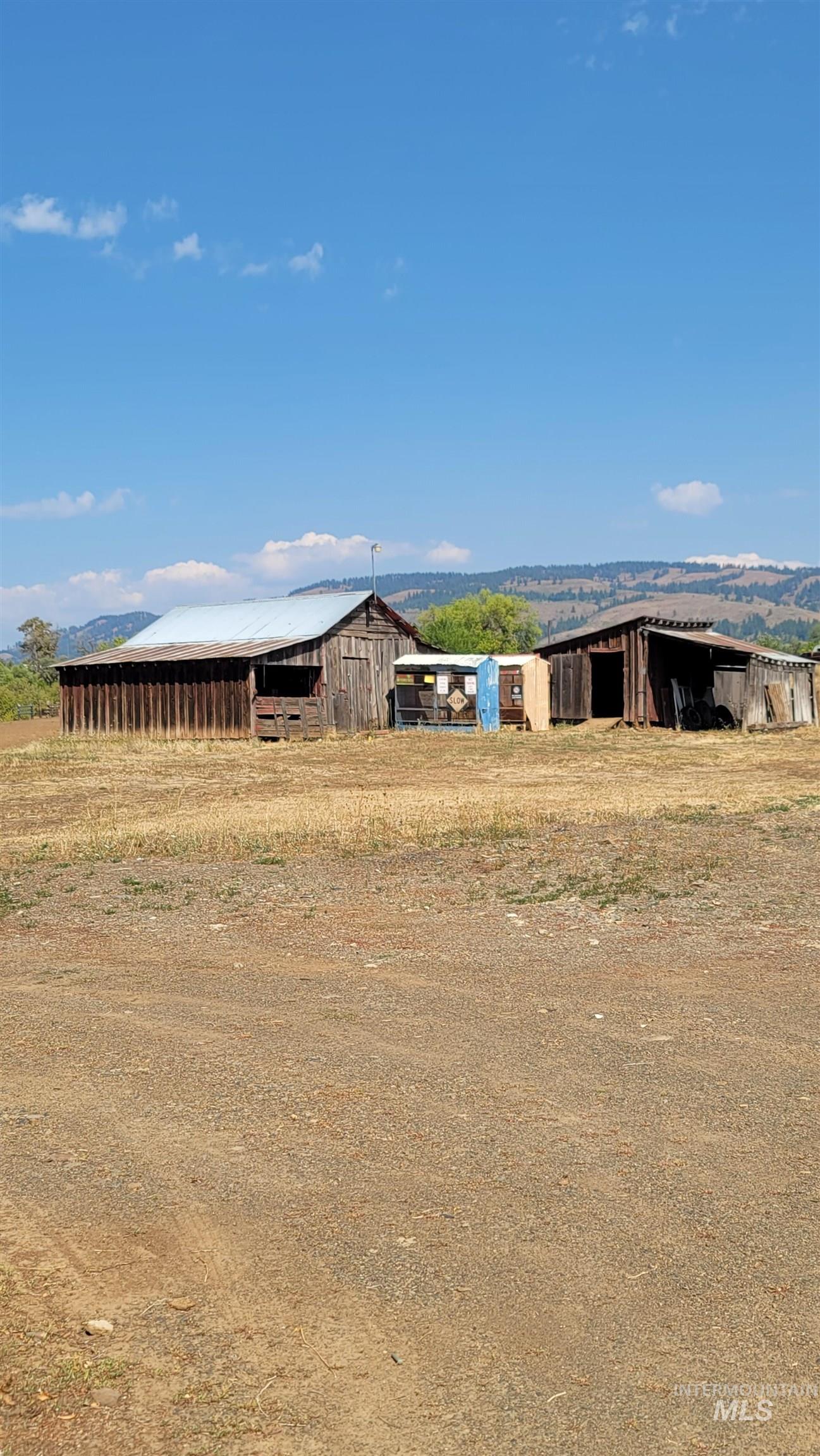 View of yard with a pole building, an outdoor structure, and a rural view