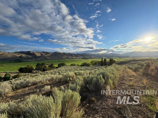 View of mountain background featuring rural landscape