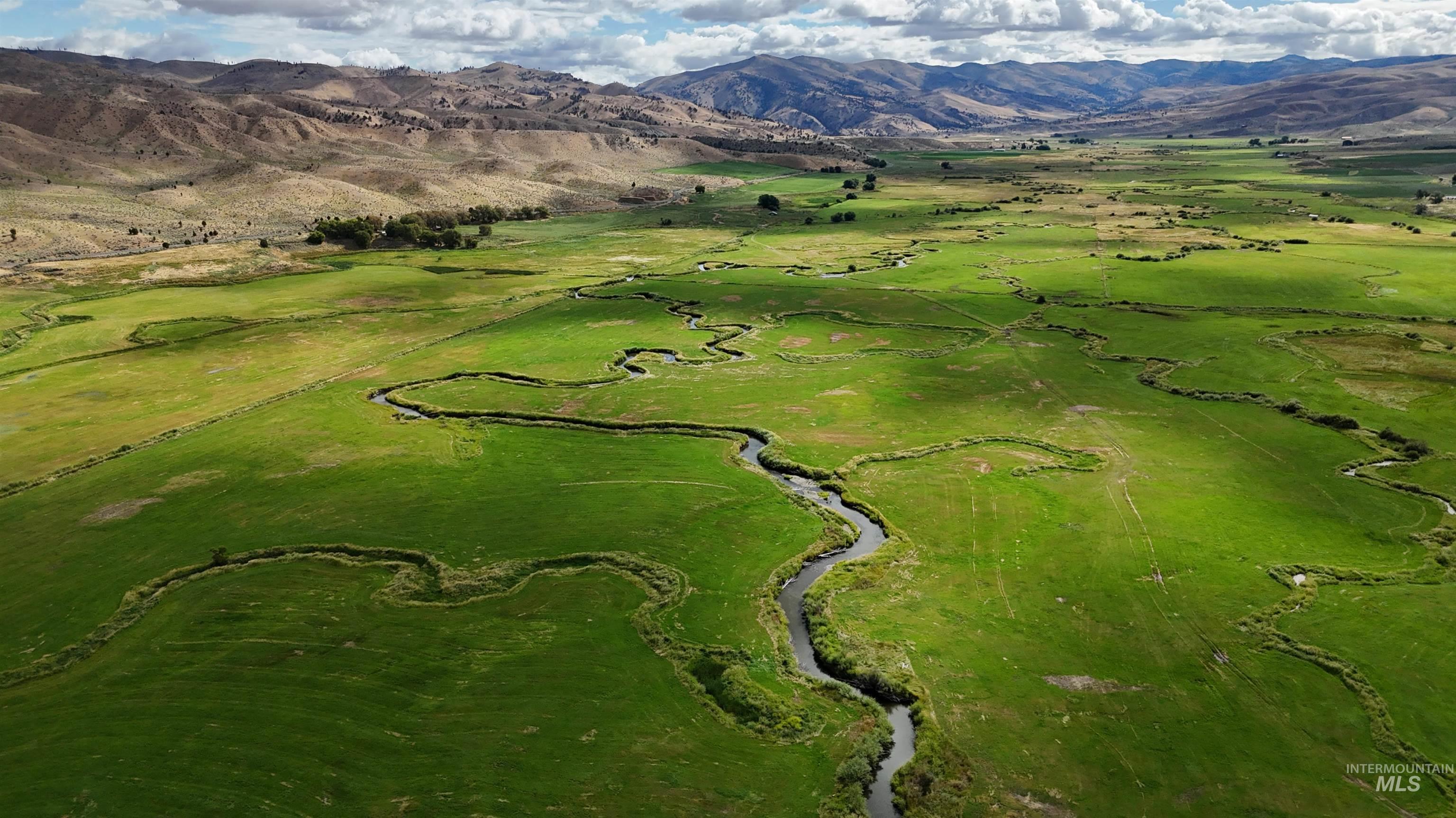 Aerial overview of property's location featuring a mountainous background