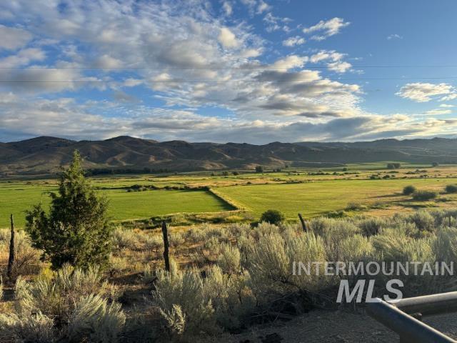 View of mountain backdrop with rural landscape