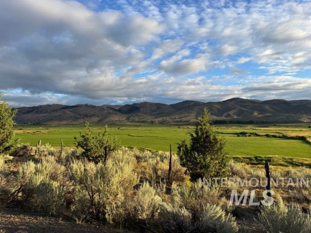 View of mountain backdrop featuring rural landscape