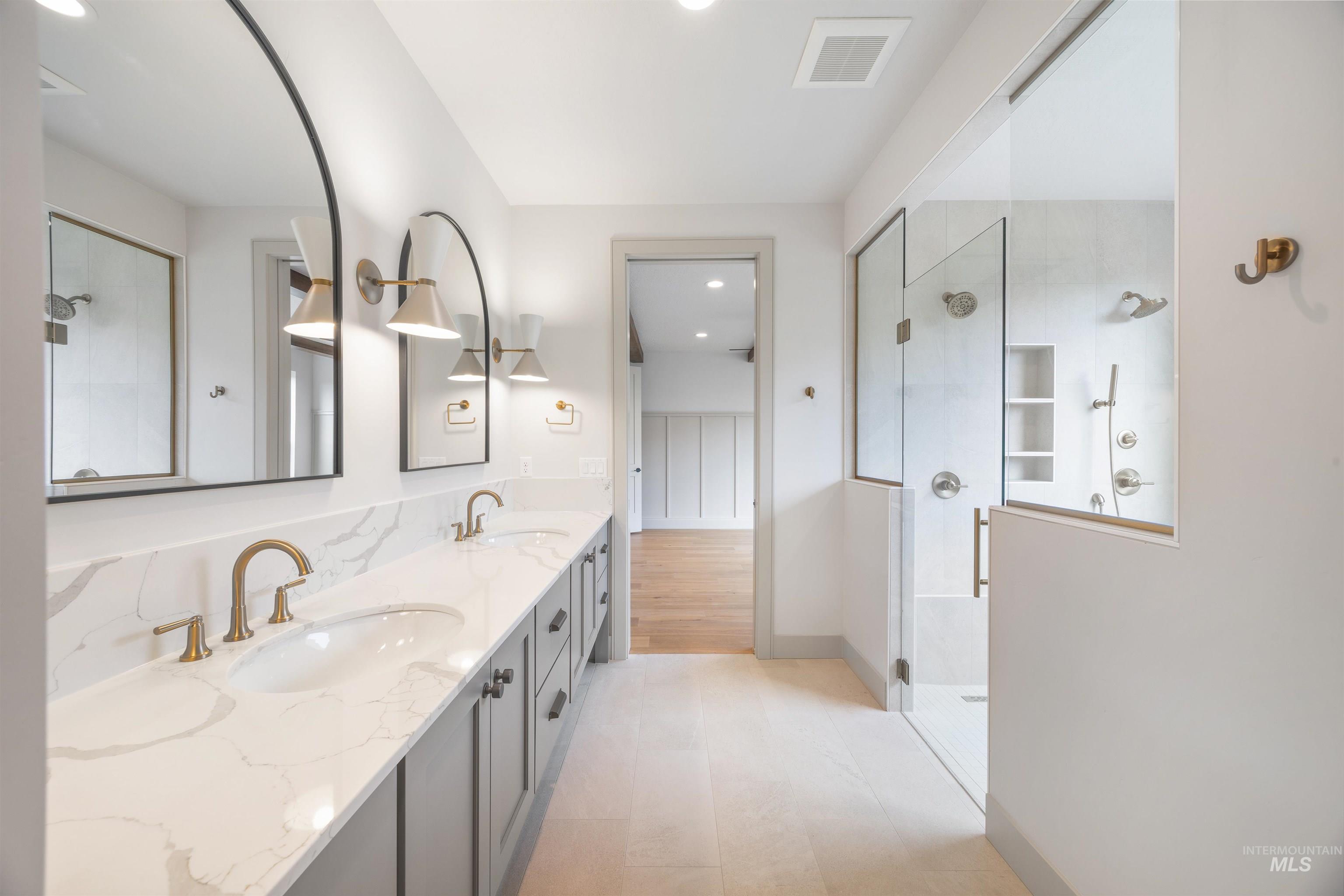 Full bathroom with walk in shower, double vanity, and recessed lighting