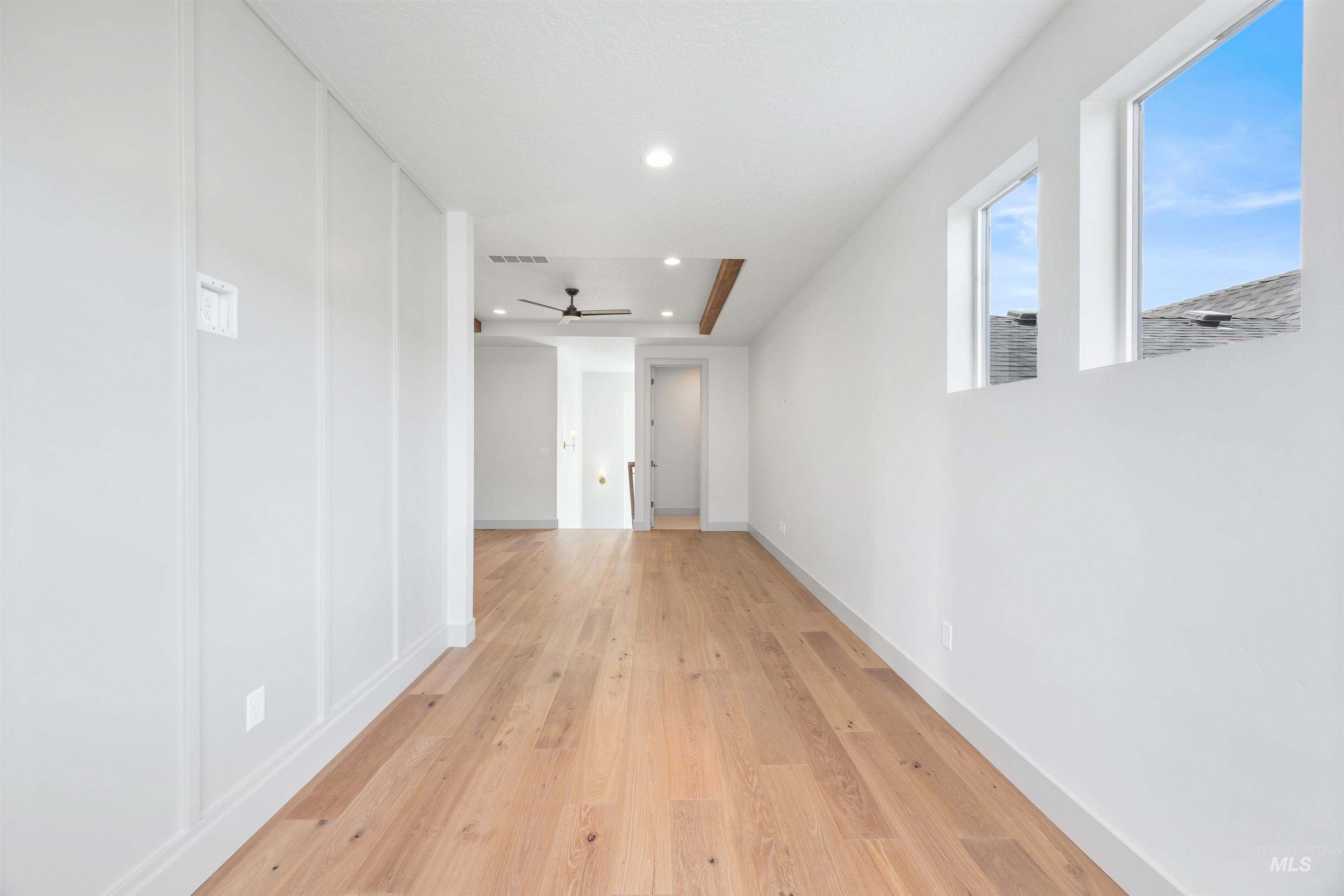 Hallway with recessed lighting and light wood-style floors
