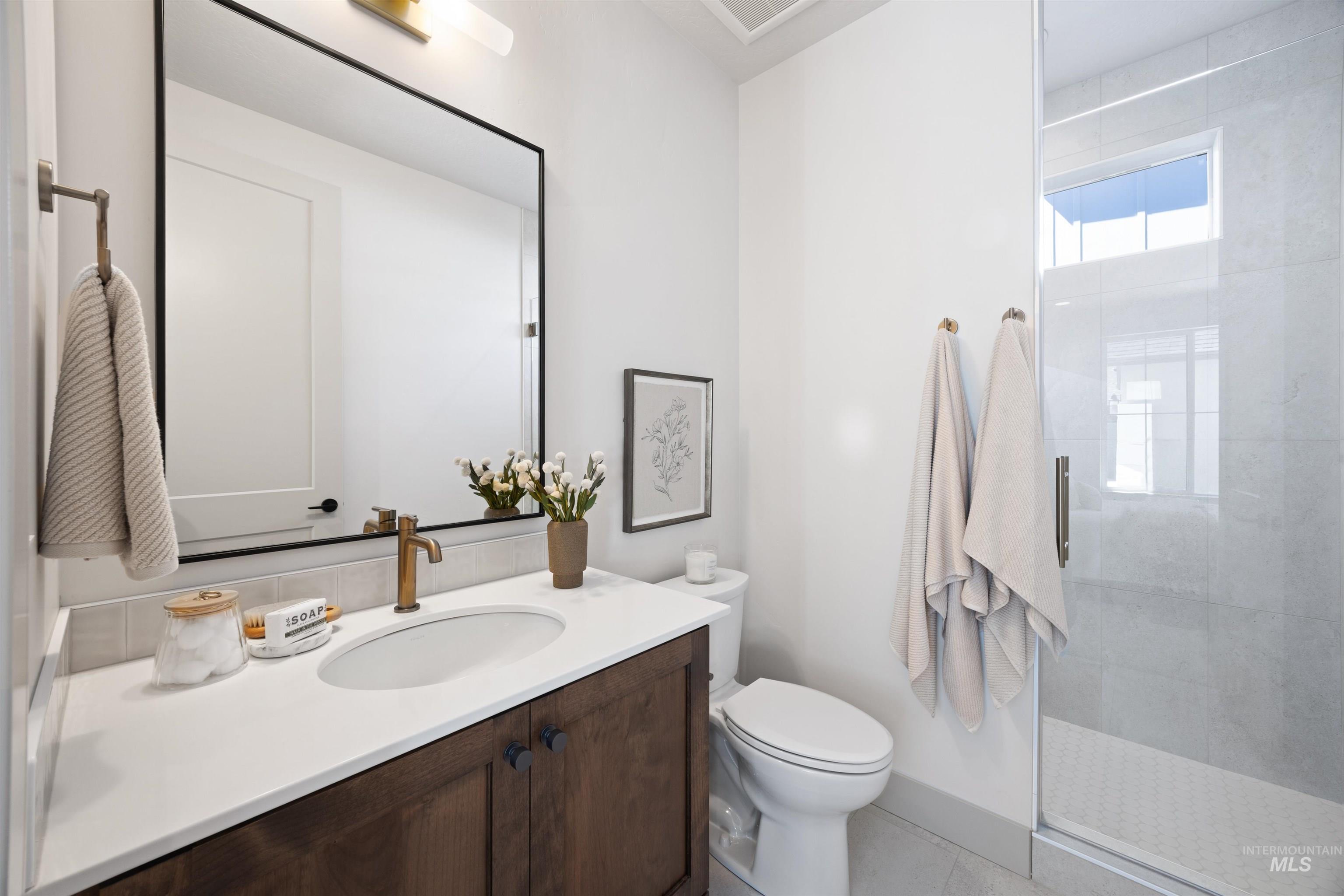 Bathroom featuring vanity and a stall shower