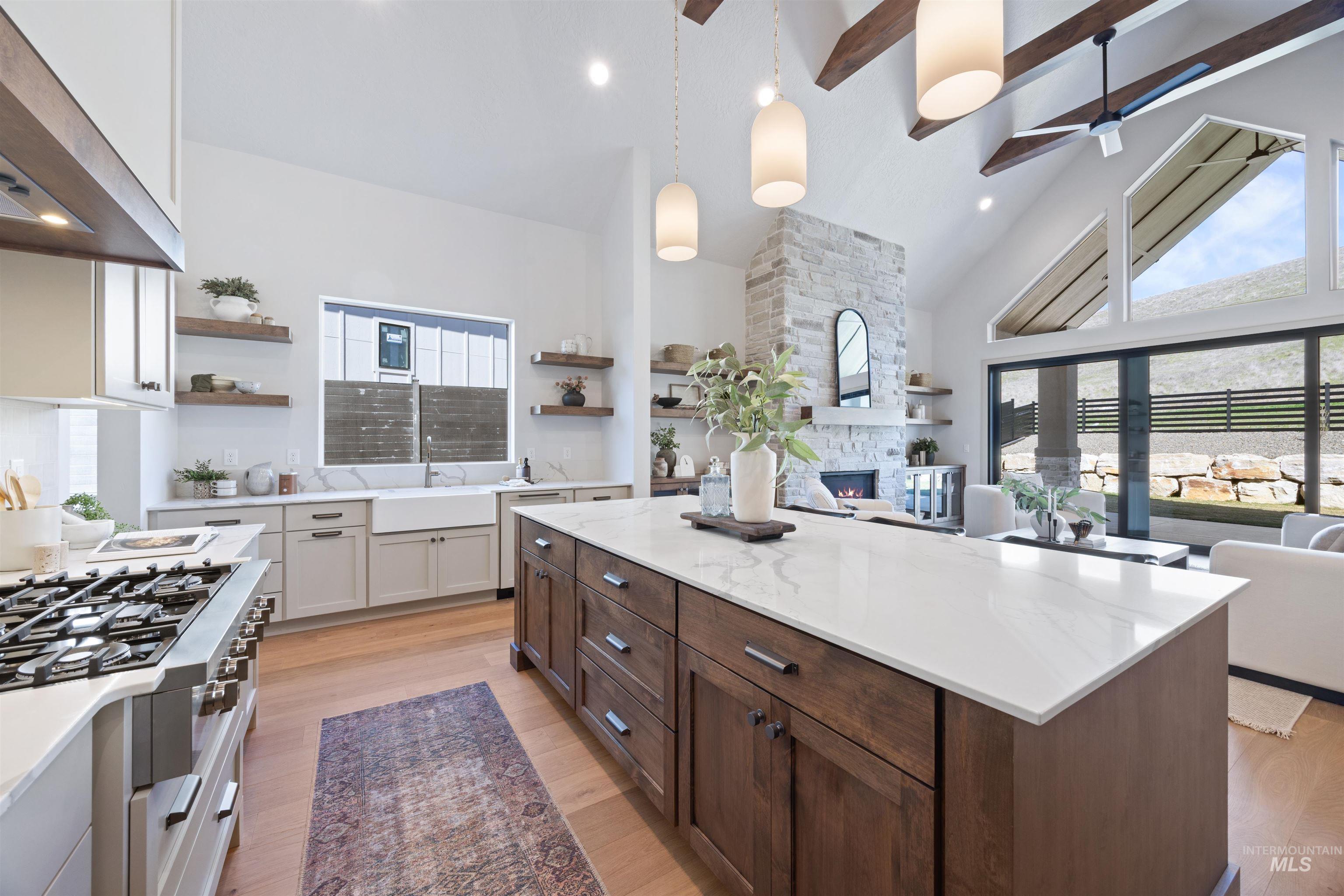 Dual tone kitchen featuring two tone color scheme, open floor plan, a center island, open shelves, and a ceiling fan