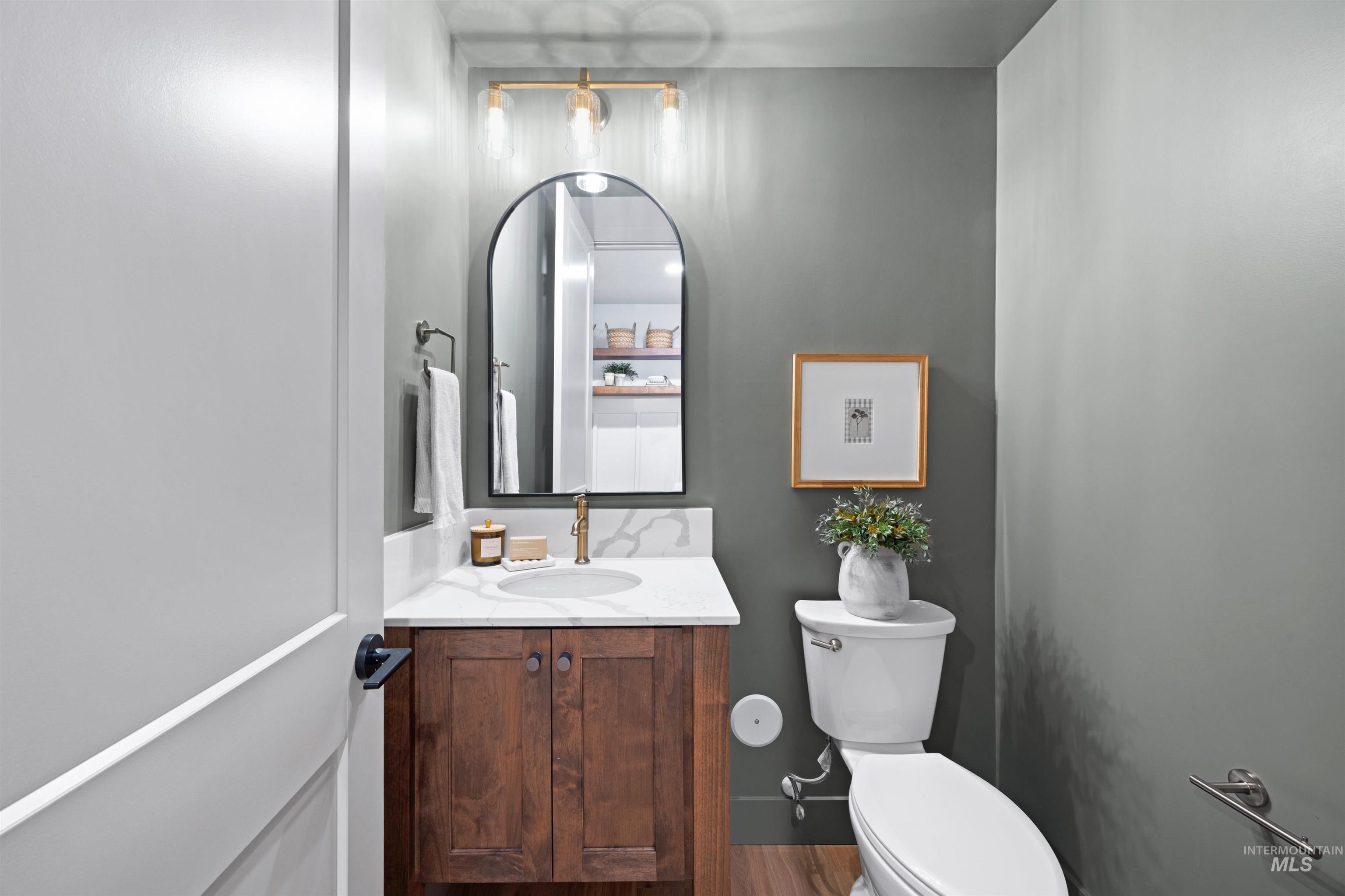 Half bathroom featuring toilet and vanity