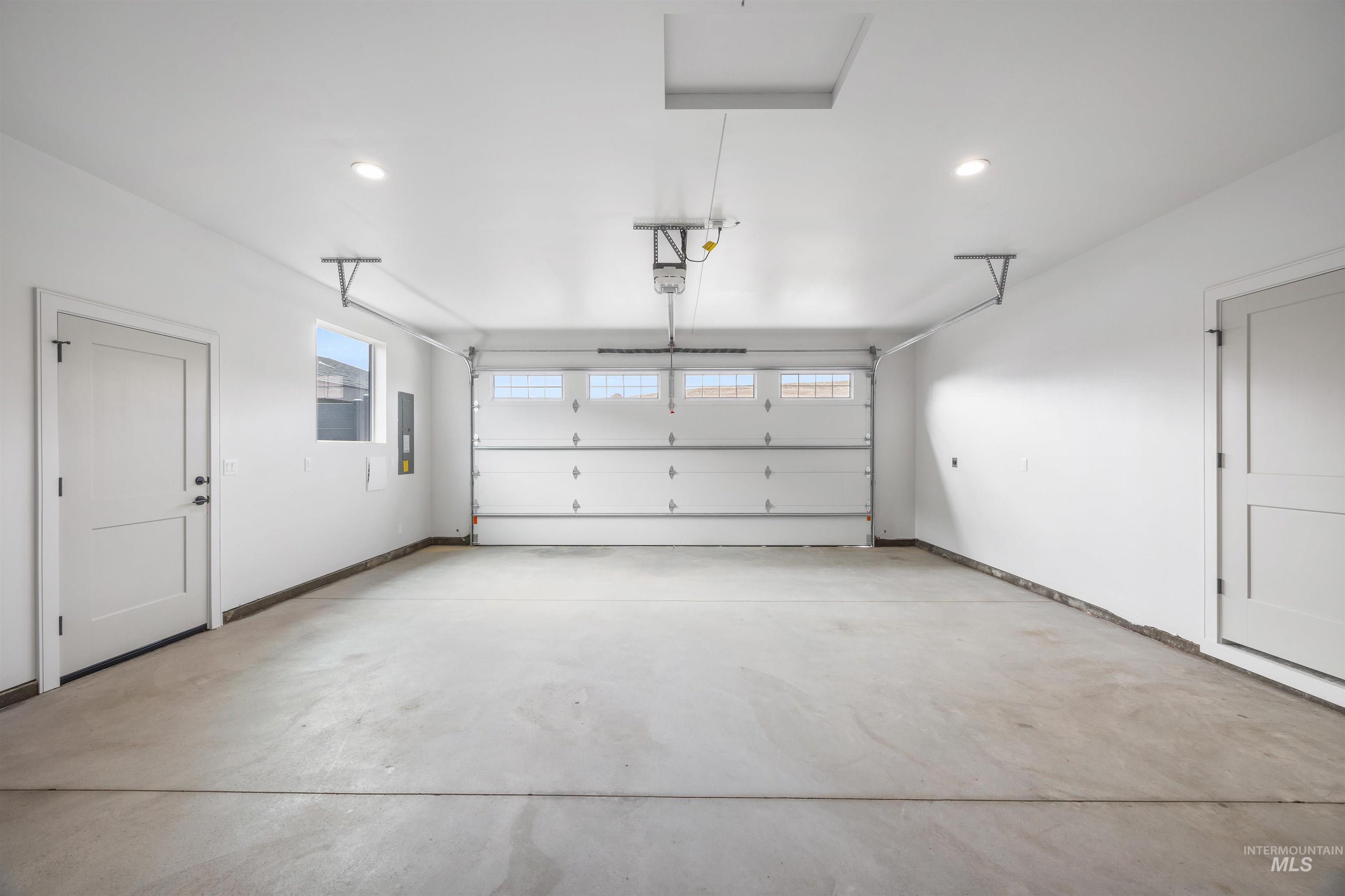 Garage with recessed lighting and electric panel